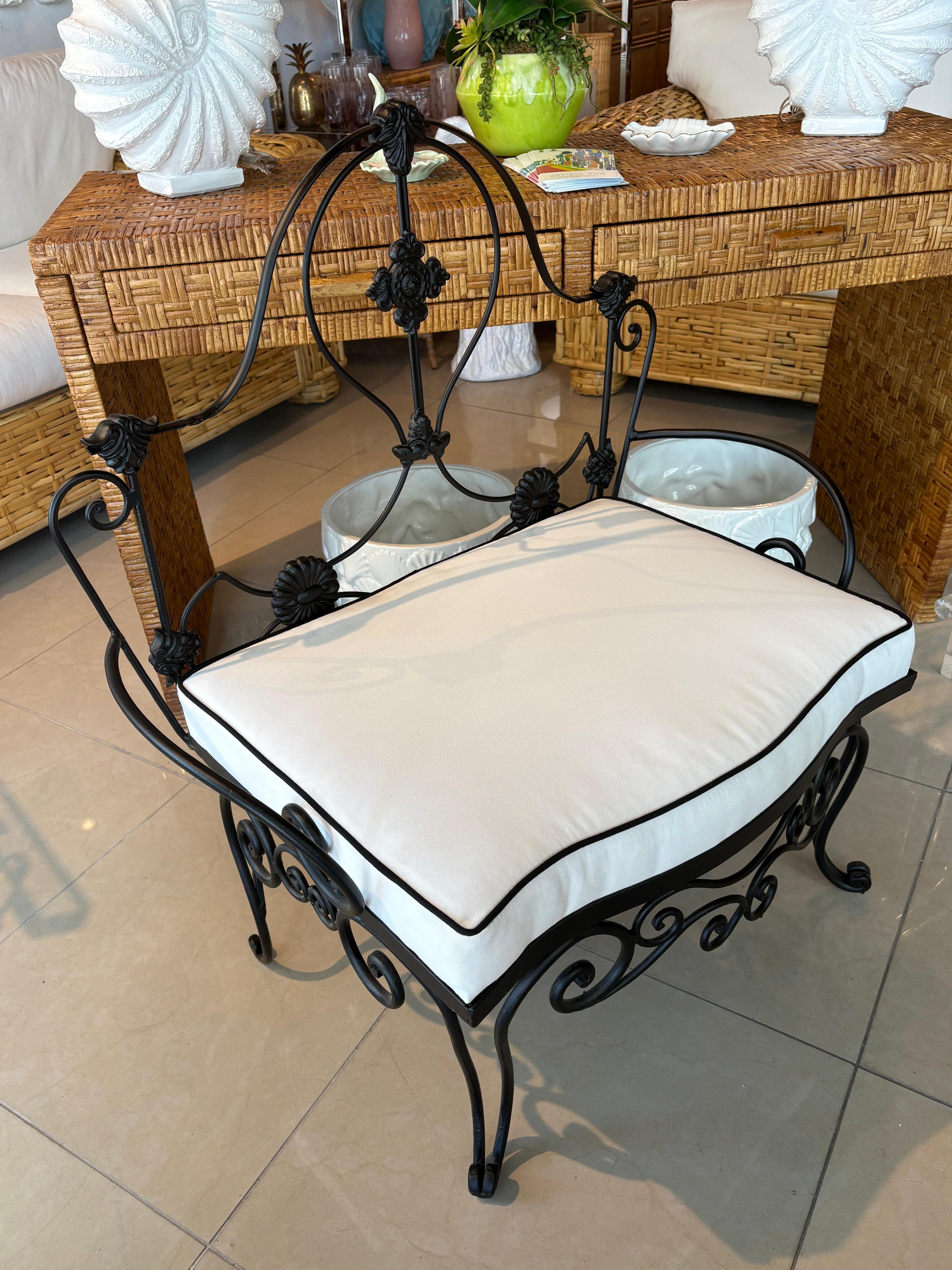 Beautiful French wrought iron garden bench stool. This can be used indoors, outdoors, patio. This has been professionally powder coated in a soft satin black. New custom cushion was made with new wood, foam, Sunbrella upholstery. Dimensions: 36.5 H
