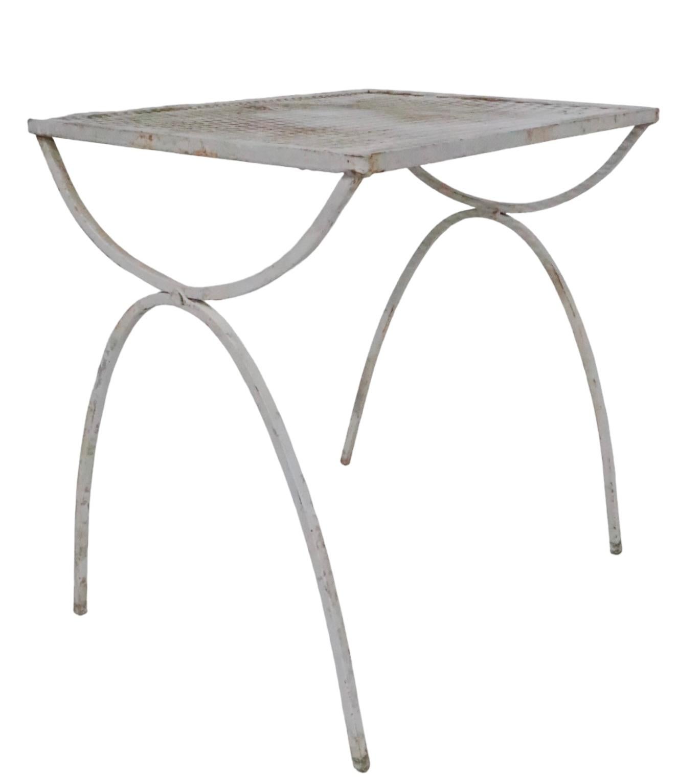 Architectural Mid Century vintage side, or end table, having a wrought iron base and frame, with metal mesh top. Designed by Maurizio Tempestini for Salterini, circa 1950's. The table is currently in later, but not new white paint finish, which