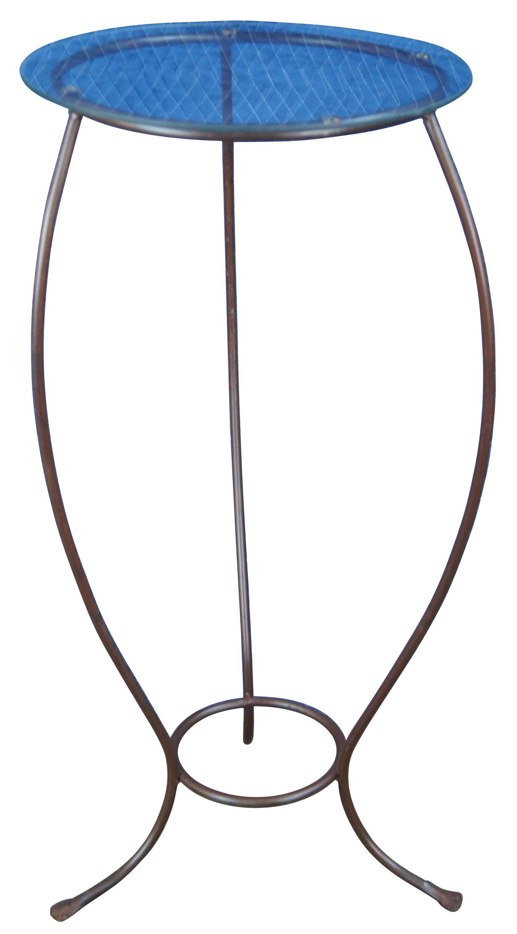 Vintage wrought iron plant stand featuring serpentine form with round glass top. Measure: 31