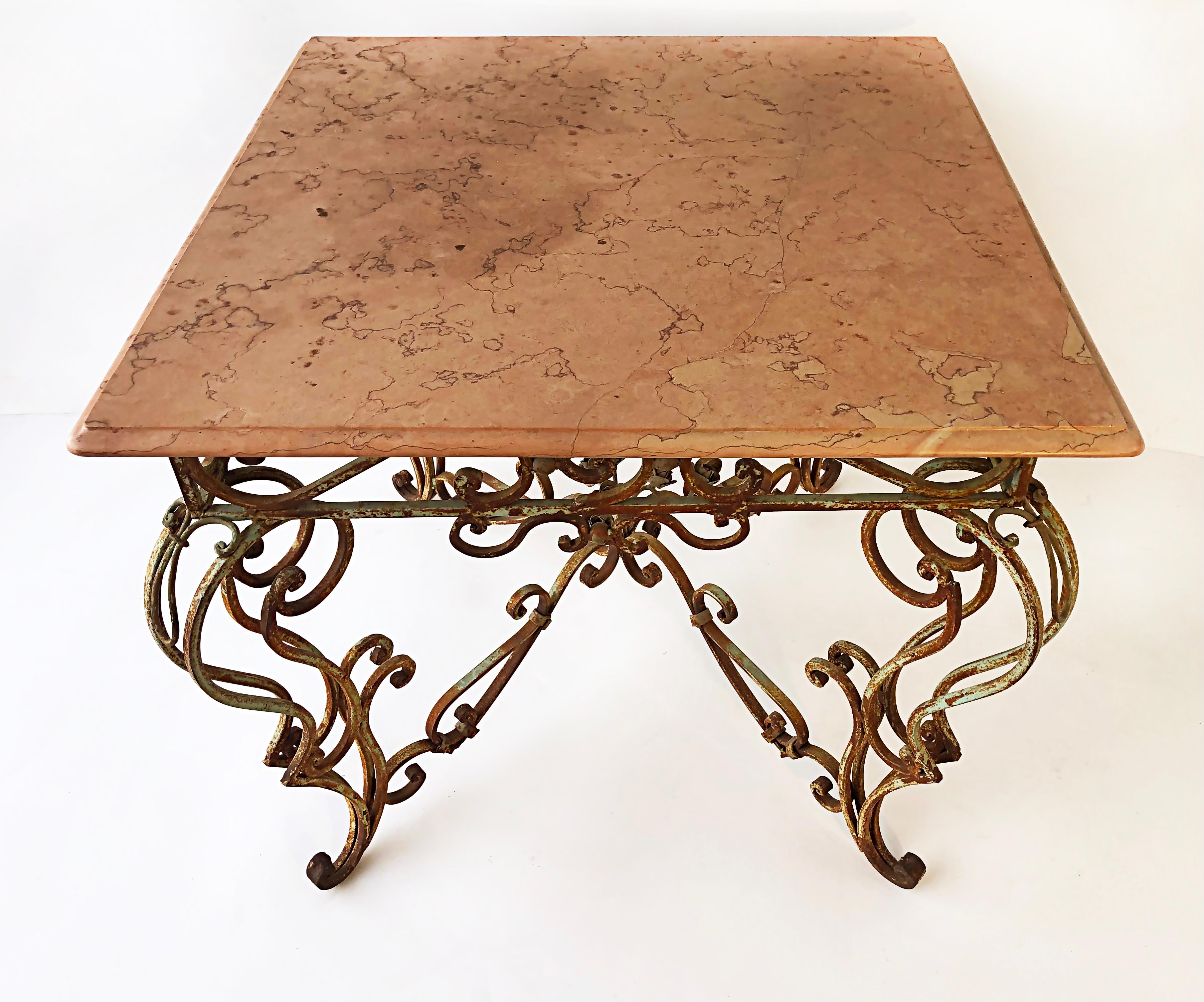 Vintage wrought iron marble top garden table with scrollwork

Offered for sale is a substantial and elegant vintage wrought iron garden table with a marble top. The marble top rests upon a scrolled and painted floral iron base. The paint has