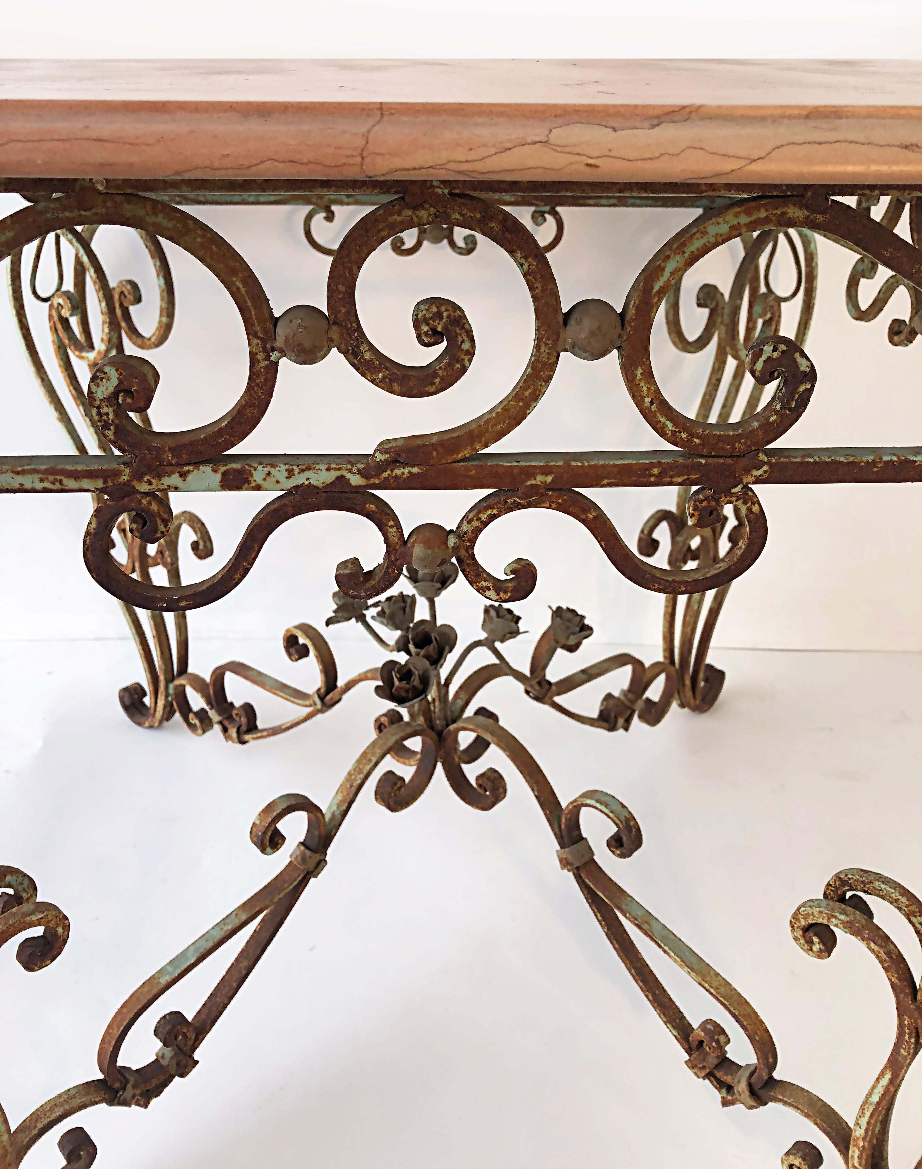 American Vintage Wrought Iron Marble Top Garden Table with Scrollwork and Flowers For Sale