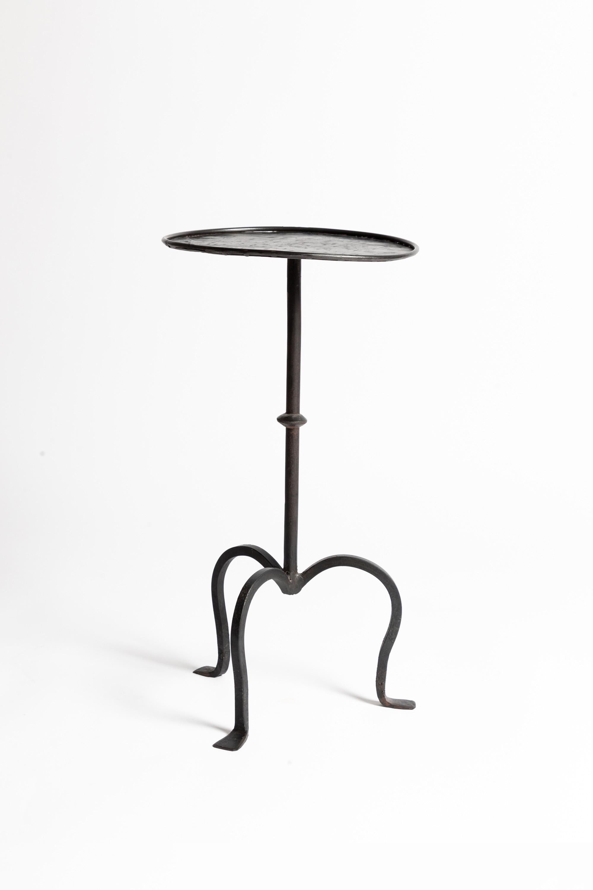 A charming vintage wrought iron martini table with a blackened steel finish.

Naively wrought with a distressed pattern to the circular top. 

Lovely overall patina. Sturdy and solid.
