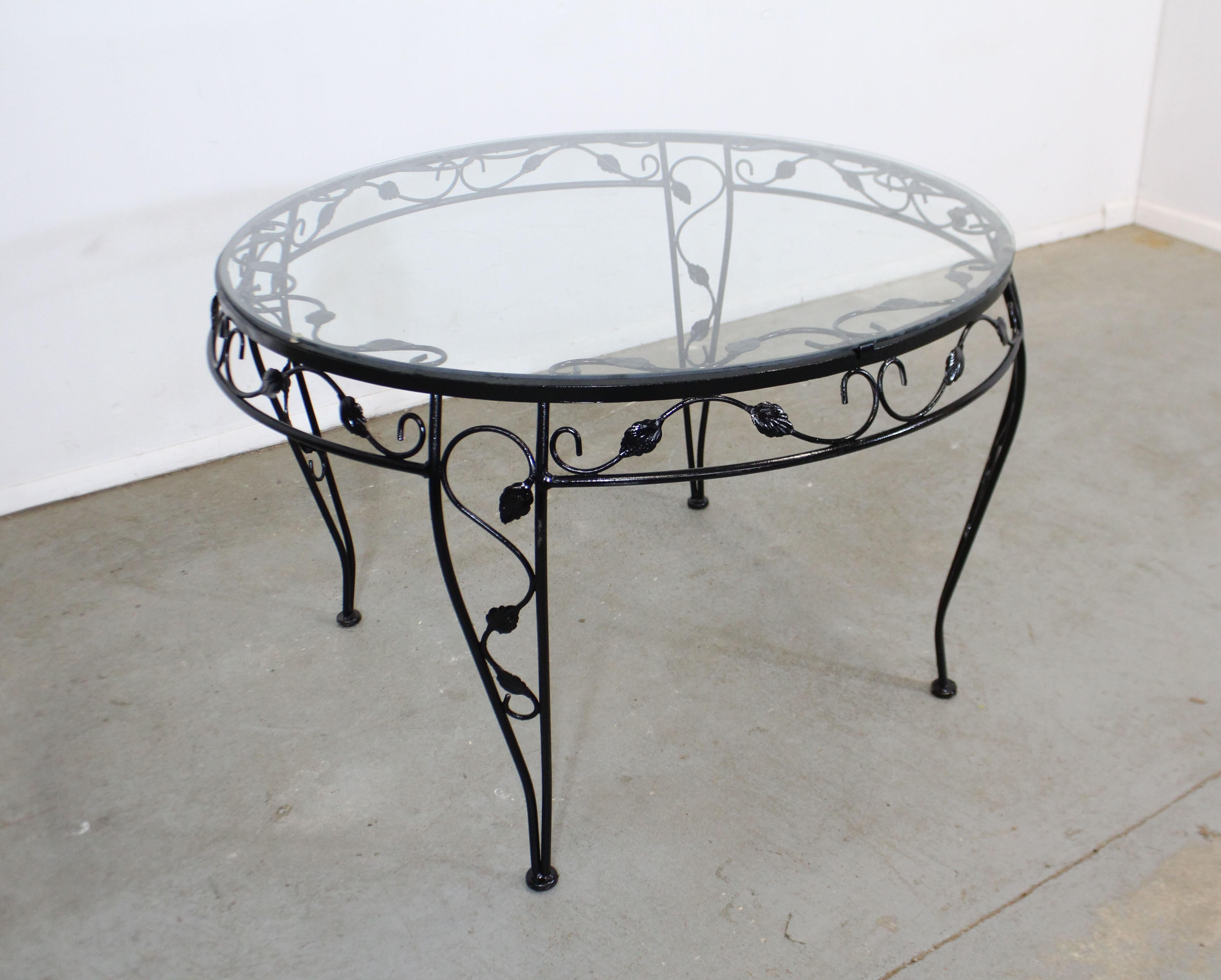 What a find. Offered is a vintage wrought iron dining table with a dogwood-leaf design and a removable glass top. Perfect for an outdoor patio space! I believe was made for Meadowcraft's 'Dogwood' line. It is in good condition with a repainted and