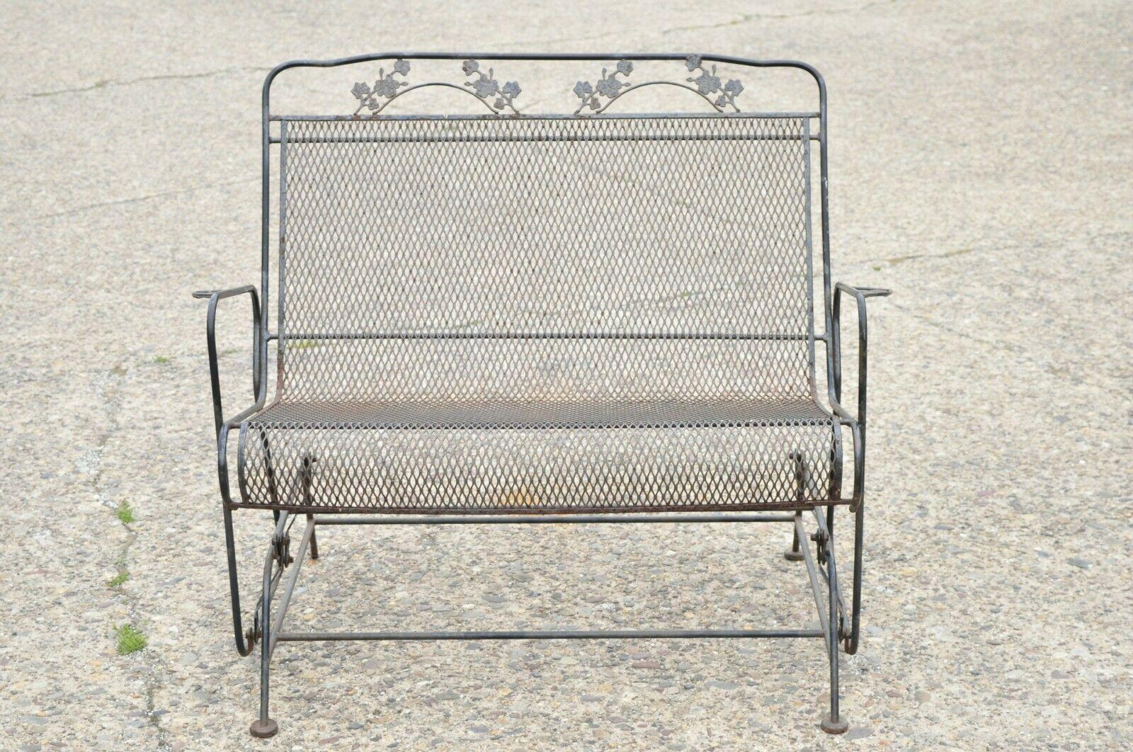 Vintage Wrought Iron Meadowcraft Woodard Maple Leaf Glider Loveseat. Item features maple leaf and vine pattern, metal mesh seat, gliding frame, wrought iron construction, very nice vintage item, great style and form. Circa Mid 20th Century.
