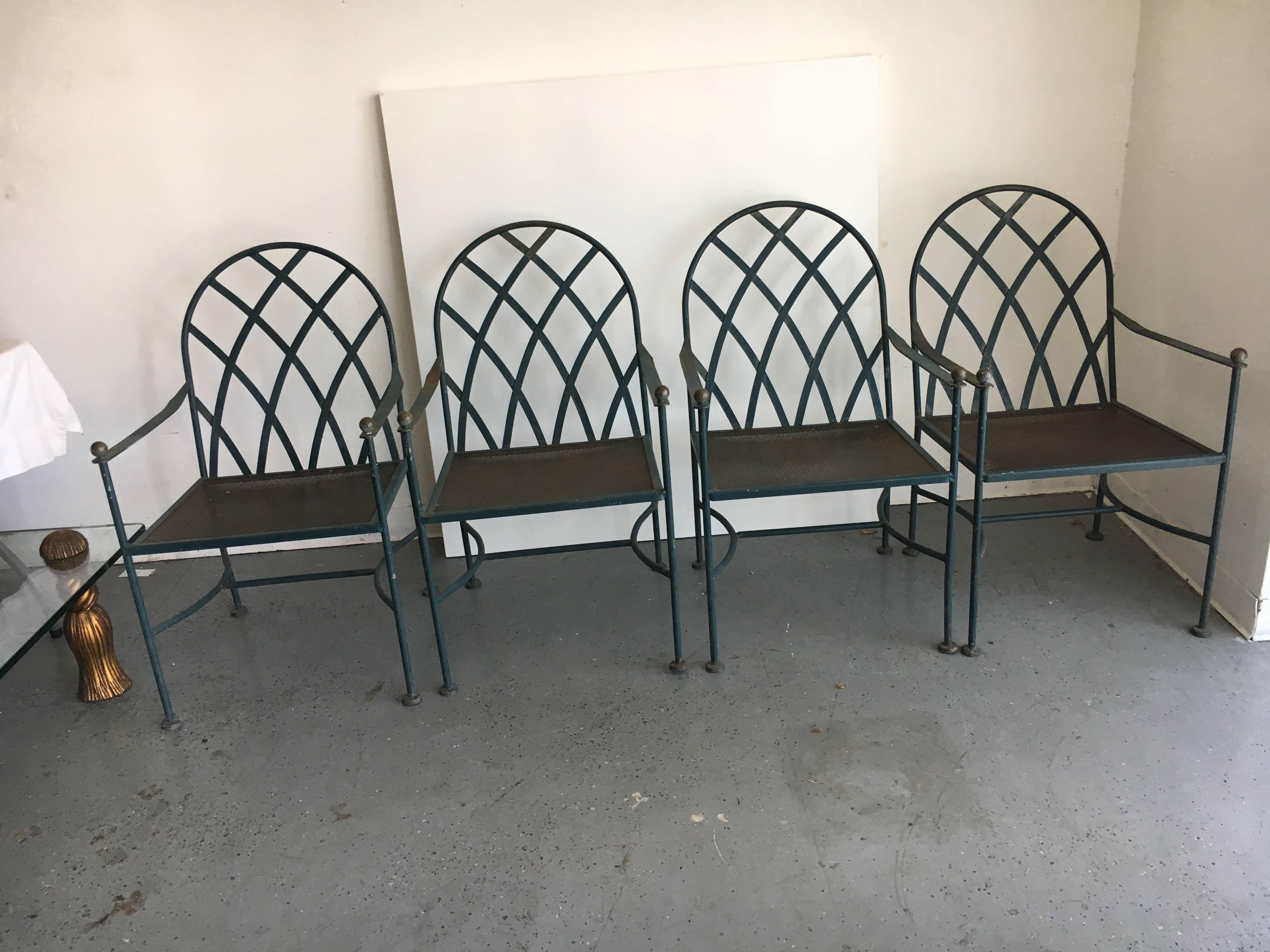 Vintage wrought iron outdoor patio dining set with four chairs, exceptional and handsome outdoor set with glass top, Mid-Century Modern. In keeping with the integrity of the era and piece, we have maintained the terrific patinated surface - each