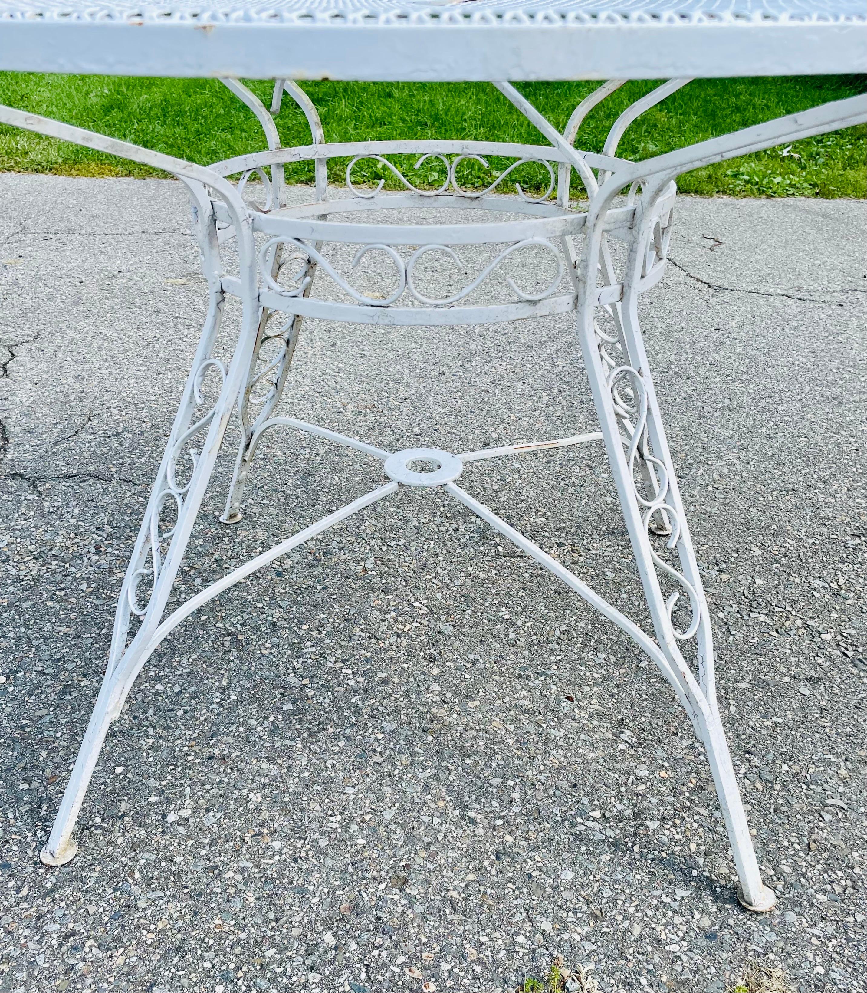 Available now and ready to ship for your enjoyment is a Vintage Woodard Wrought Iron Outdoor Table Mesh and Scroll

48 inches in Diameter

Scrolling detail through base and legs

Perfect for any deck, garden, or patio.



