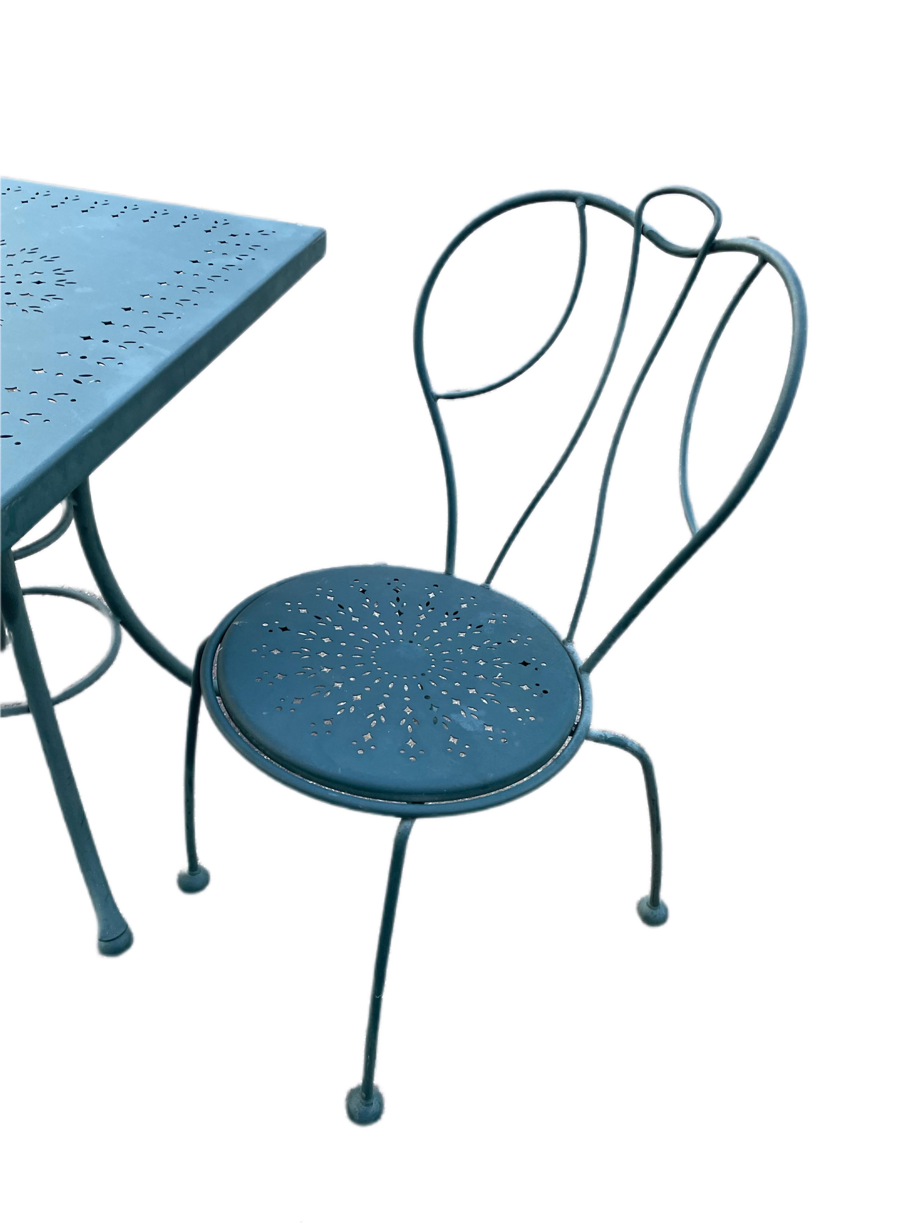 Available now for your enjoyment and ready to ship is a Vintage Wrought Iron Patio Cafe set made by Woodard. 

This lovely Wrought Iron three piece Set of a pair of Chairs and matching table are the perfect addition to any garden, terrace, or