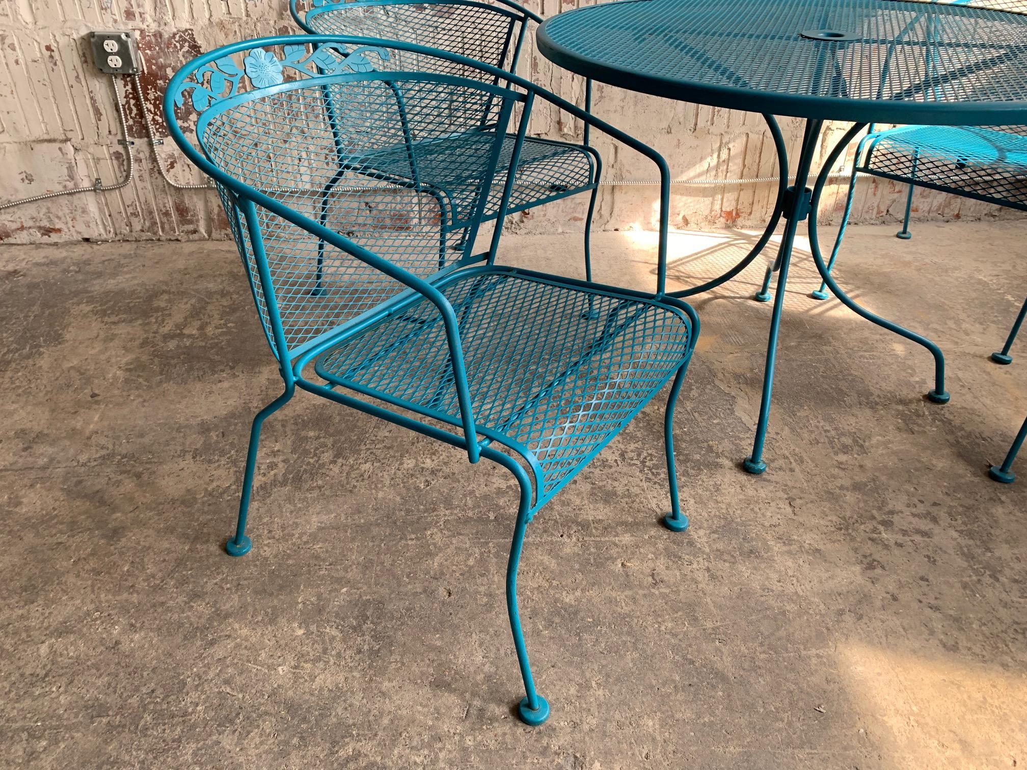 Vintage wrought iron patio set circa 1950s in the manner of Salterini or Woodard. Satin turquoise blue finish. Very good structural condition with minor signs of age appropriate wear to finish. Set includes table and 4 chairs as shown.
Table