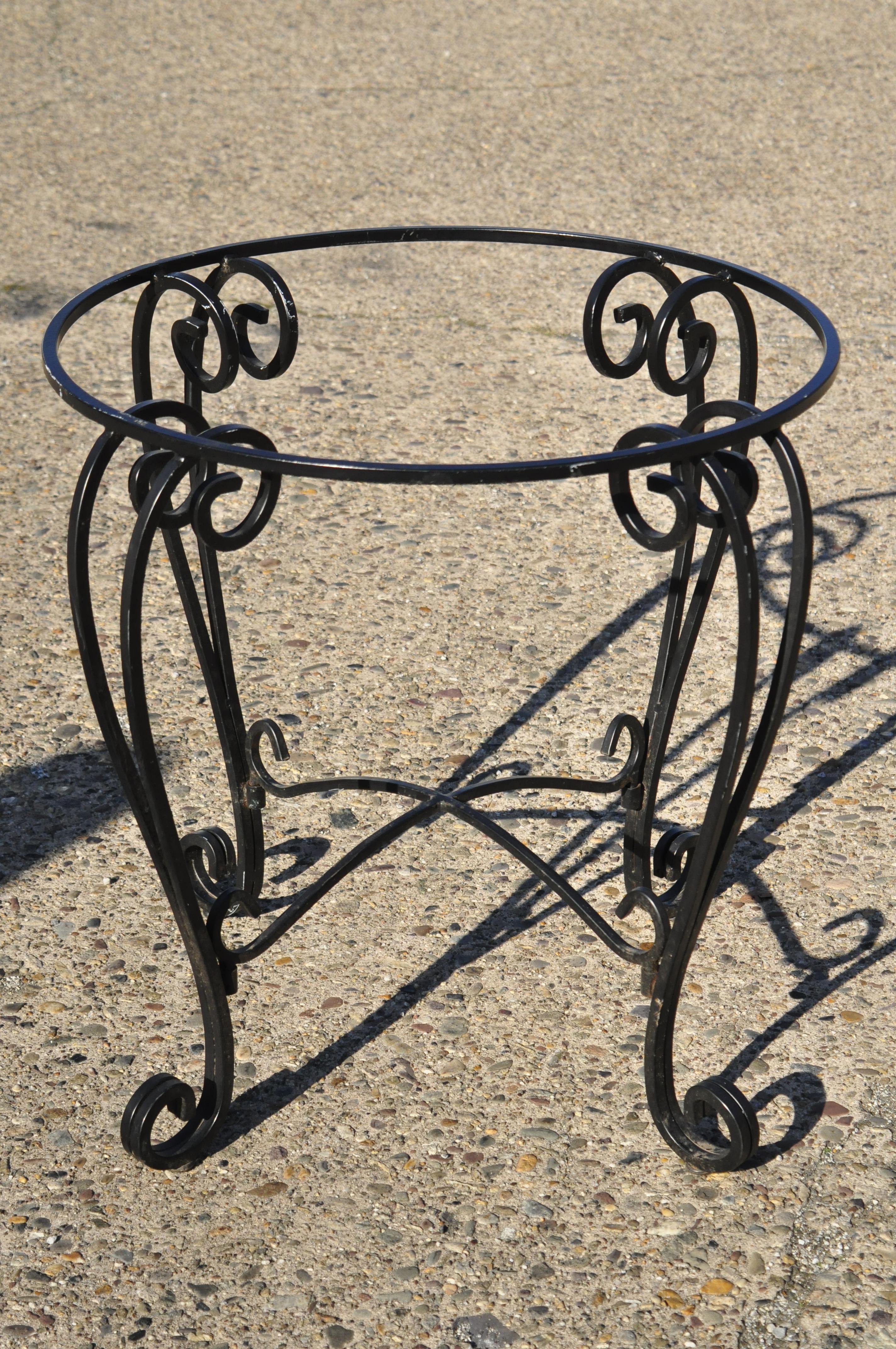 Vintage wrought iron round scrollwork pedestal base dining room table. Item features heavy wrought iron scrolling base, round frame, stretcher support, quality craftsmanship, great style and form, circa mid-late 20th century. Measurements: 29