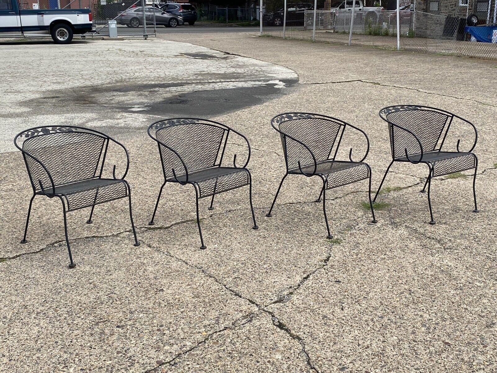 Vintage wrought iron scroll arm Garden Patio dining set 4 chairs - 5pc Set. Item features (4) armchairs, (1) Round dining table, scrolling wrought iron frames, possibly Meadowcraft Dogwood pattern. Circa Mid to late 20th century. Measurements: