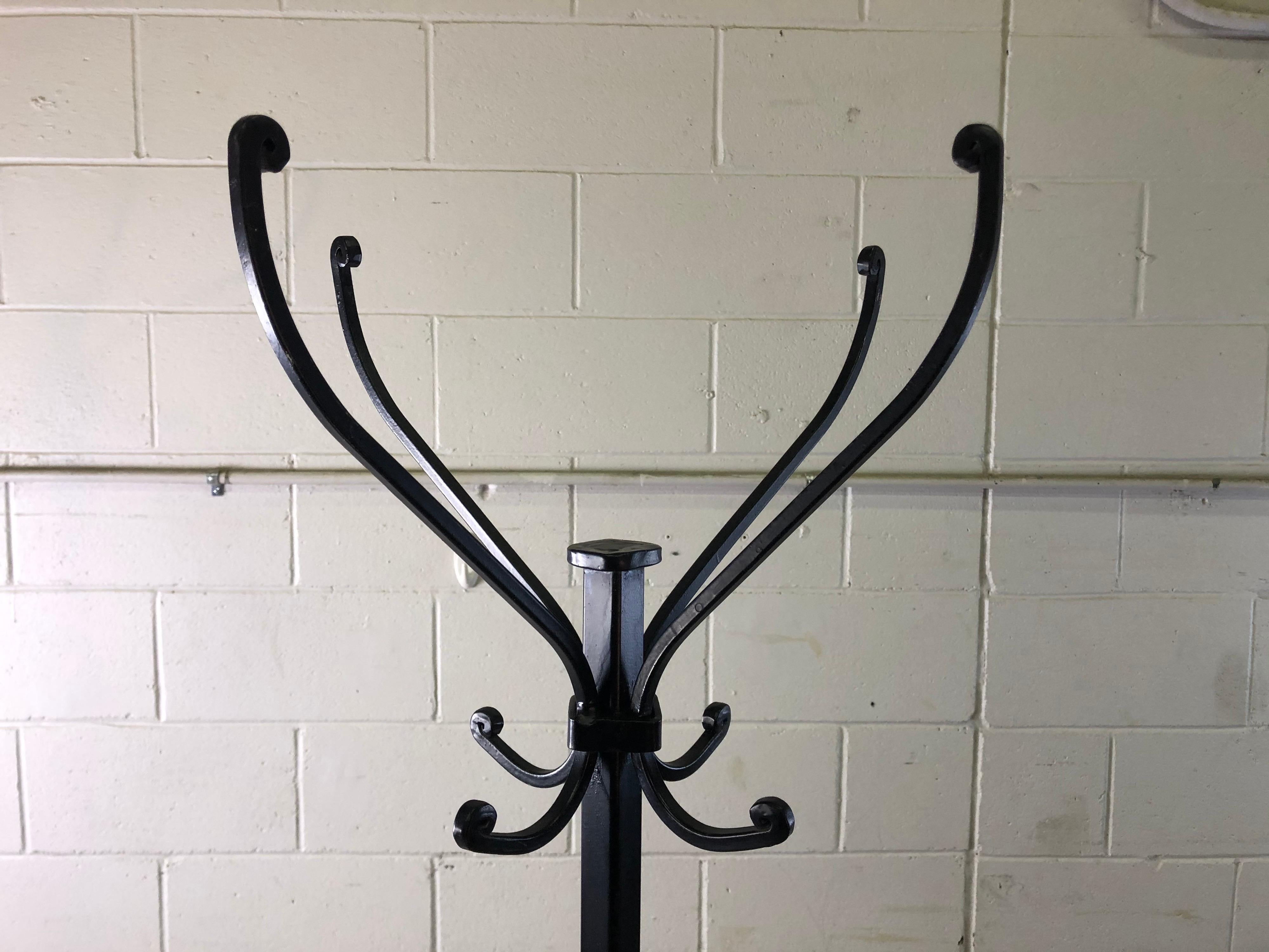 Vintage solid wrought iron tall coat rack. The coat rack also can hold umbrellas. No marks. Very sturdy.