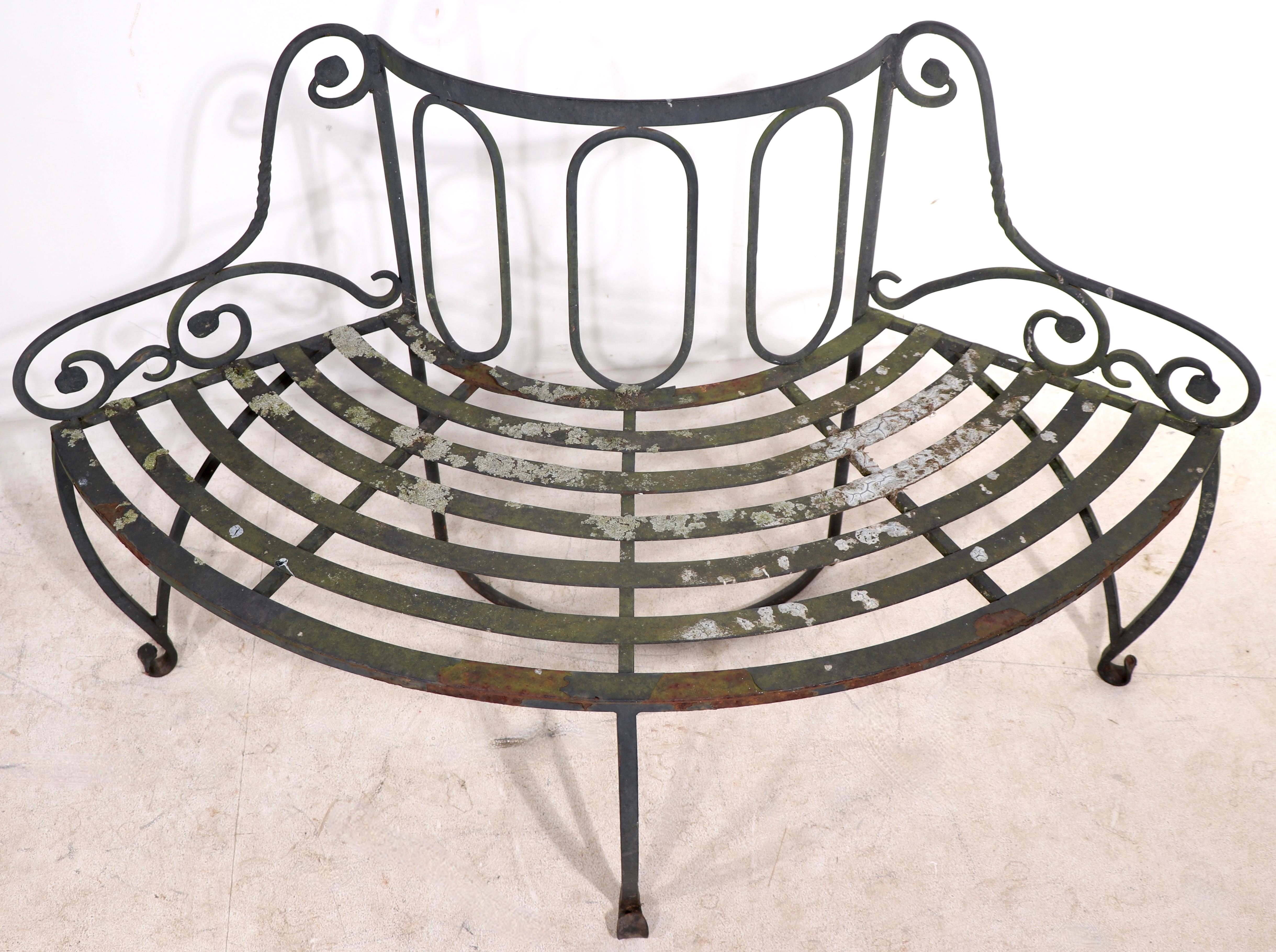 Charming wrought iron three section tree surround bench, in appealing patinated finish. The bench consists of three sections each approximately 48 W x 16 D x 29 H. When assembled the bench is 56 Total Dia x 24 Dia. at center. Seat H 16 x Arm H 21 (