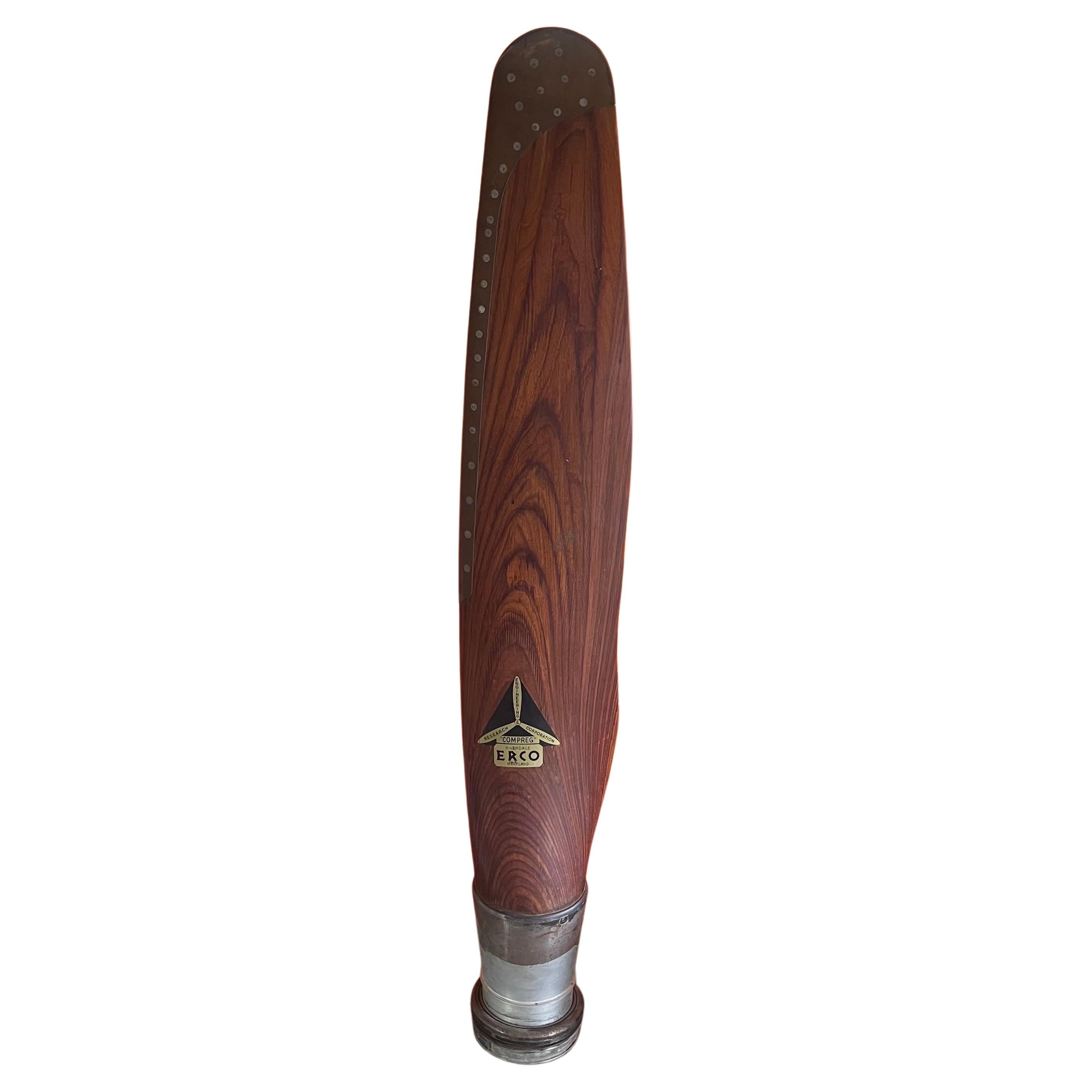 A vintage original WWII Compreg constant speed wood and brass propeller blade by Engineering and Research Corporation (ERCO) of Riverdale, Maryland, circa 1940s.  Due to the wartime shortage of aluminum, these were built primarily of hard wood.  The