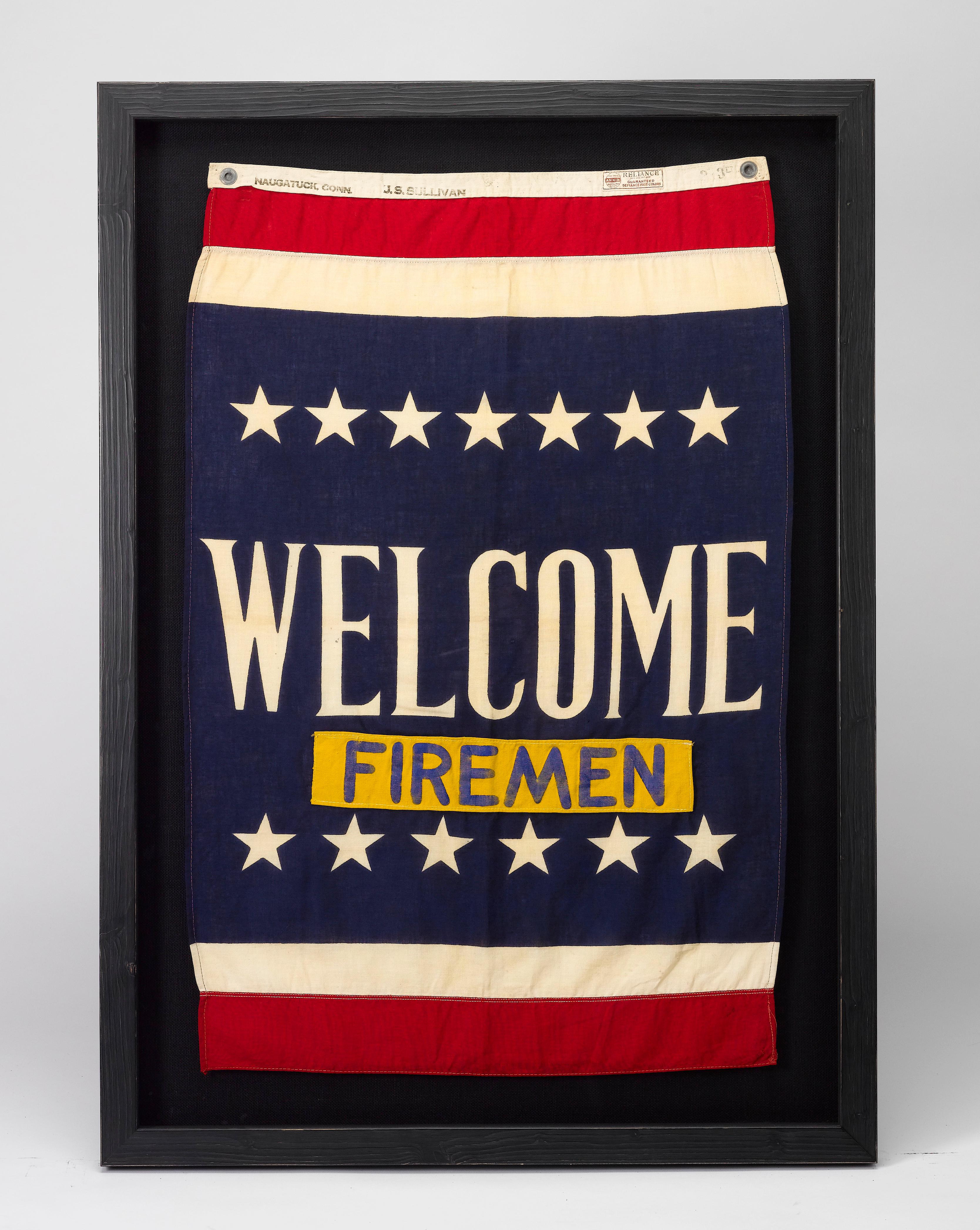 This is a beautifully preserved WWII Navy aircraft carrier banner, emblazoned with a welcome for the ship's firemen.

The banner is partially printed and has sewn elements. The flag's field is dyed a rich navy blue, with a resist dyed white stripe