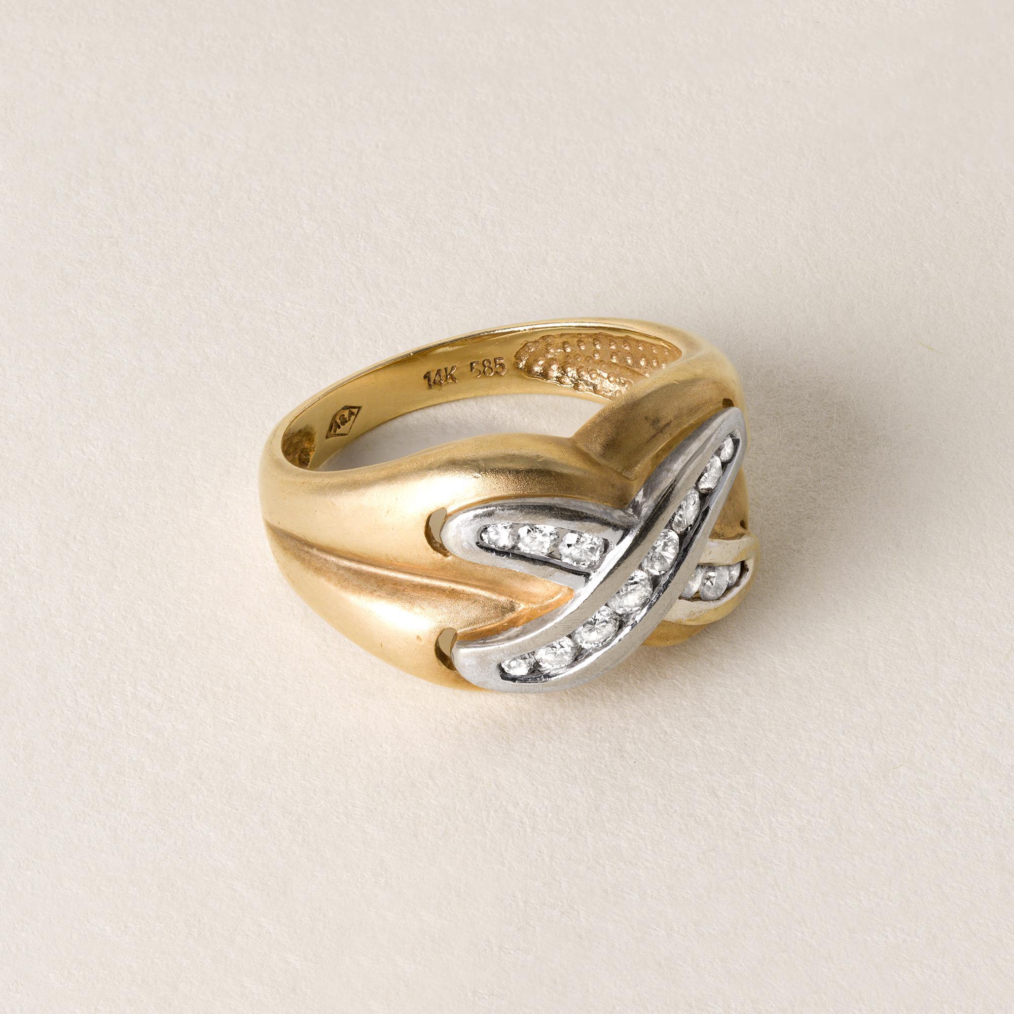 Circa 1980
14 round brilliant diamonds weigh ~ 0.35 carats
G-H SI
channel set in X design
Stamped 14k 585 inside shank
5.6 grams
Band measure 11mm tapering down to 2.9mm
Ring size 6.75
Ring size 7