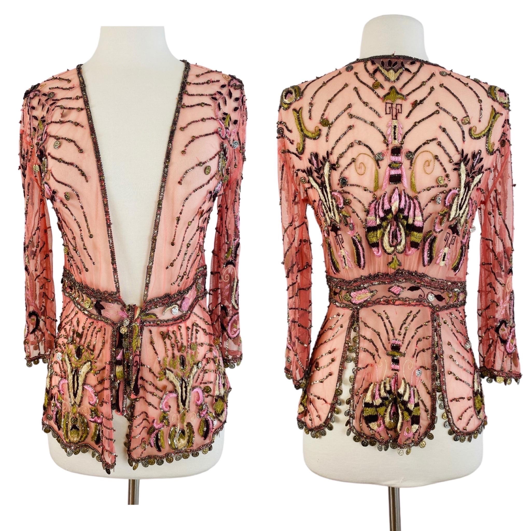 2004 Roberto Cavalli blouse
Pink mesh fabric with embroidery throughout
Gold + silver tone tiny coins throughout + at hem of sleeves + across the bottom (does make jingly noise)
Deep V open style beaded neckline
Long 3/4 tapered sleeves
Fitted