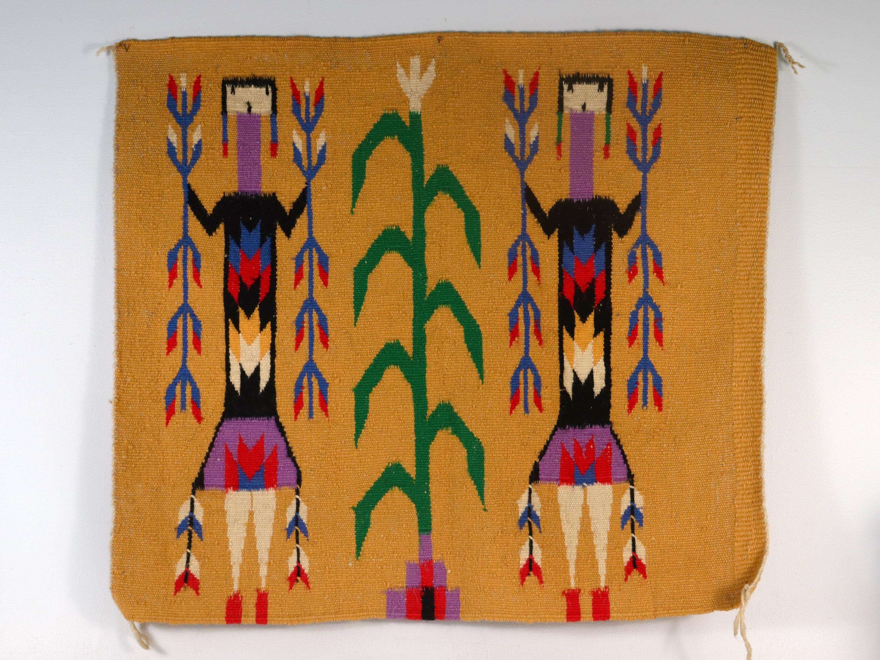 A fine wool Yei Navajo weaving.

In the form of a small rug or mat. (Potentially perfect for a large pillow top)

Depicting two corn people or deity figures flanking a cornstalk on a yellow/orange ground.

Found from a local Virginia