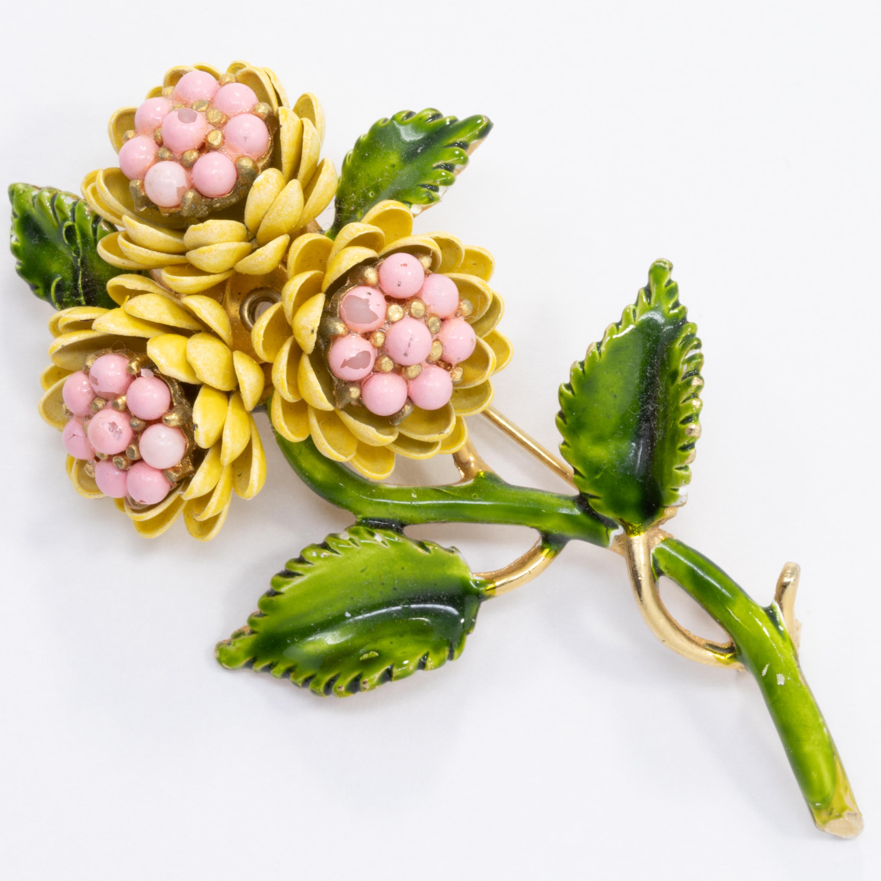 A colorful, matching set of flower clip on earrings and brooch.

Resin painted with green, yellow, and pink enamel. Gold-plated on the back.

Some wear of enamel and plating - please see photos!

