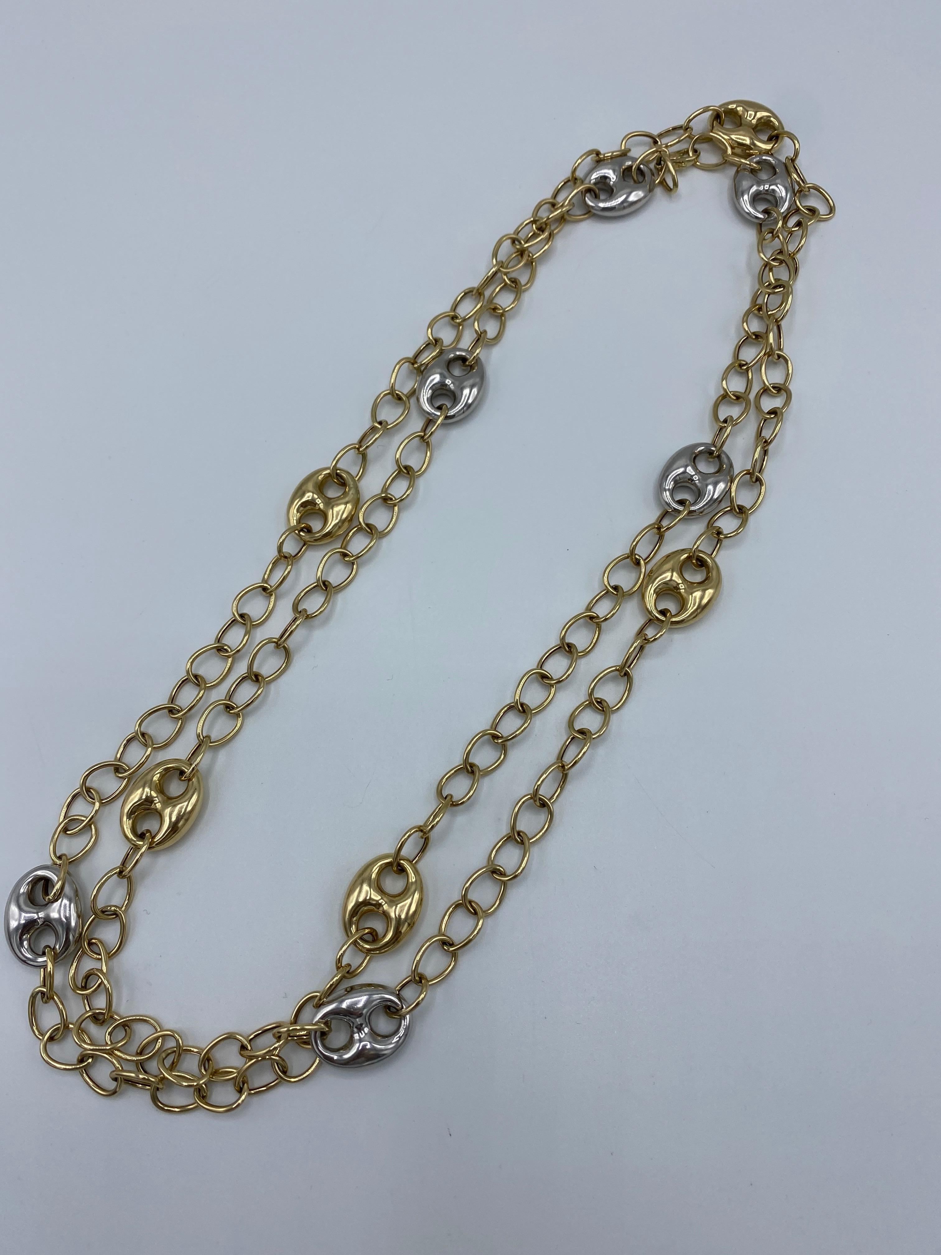 Product details:

The chain is made out of 14 karat yellow and white gold, it features mariner and oval links and lobster clasp closure. 
Measurements: 52 inches long and 5/8 inches wide.
Total weight is 47.9 grams.
Hallmarks: 14K Italy.