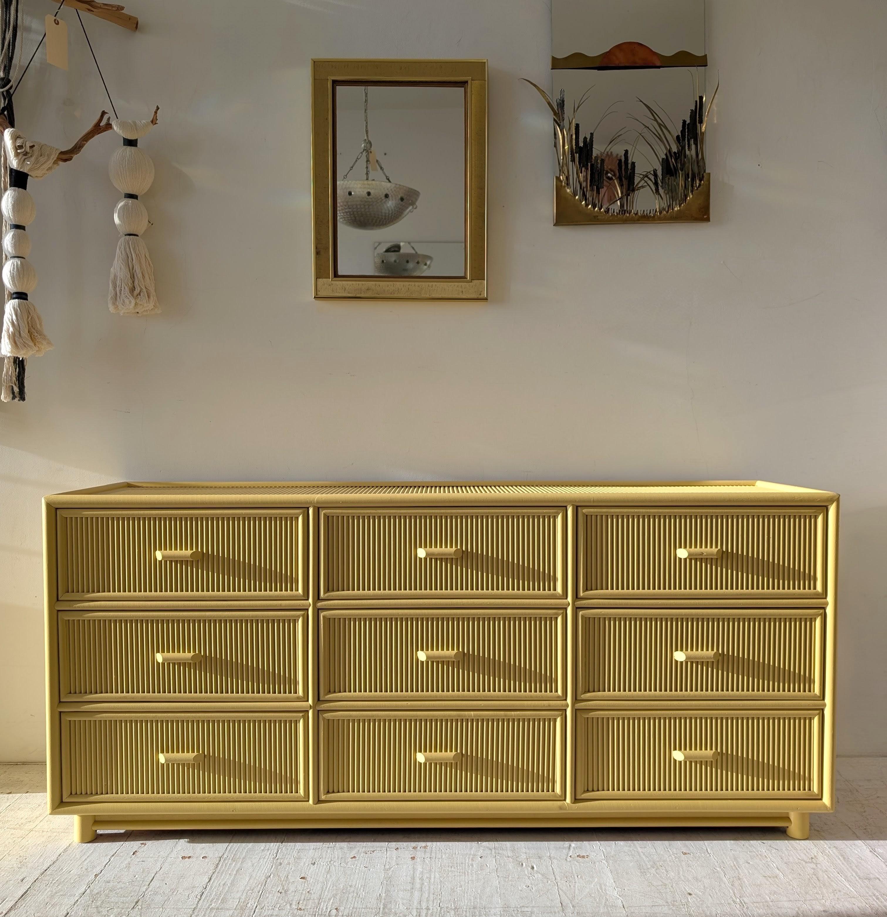 Vintage cane & pencil reed sideboard with drawers, in a soft yellow finish, USA 1970s/80s.  

The sun was in and out while I was photographing this- colour looks much more vivid in the bright sun, but more like a pale custard in reality (see the