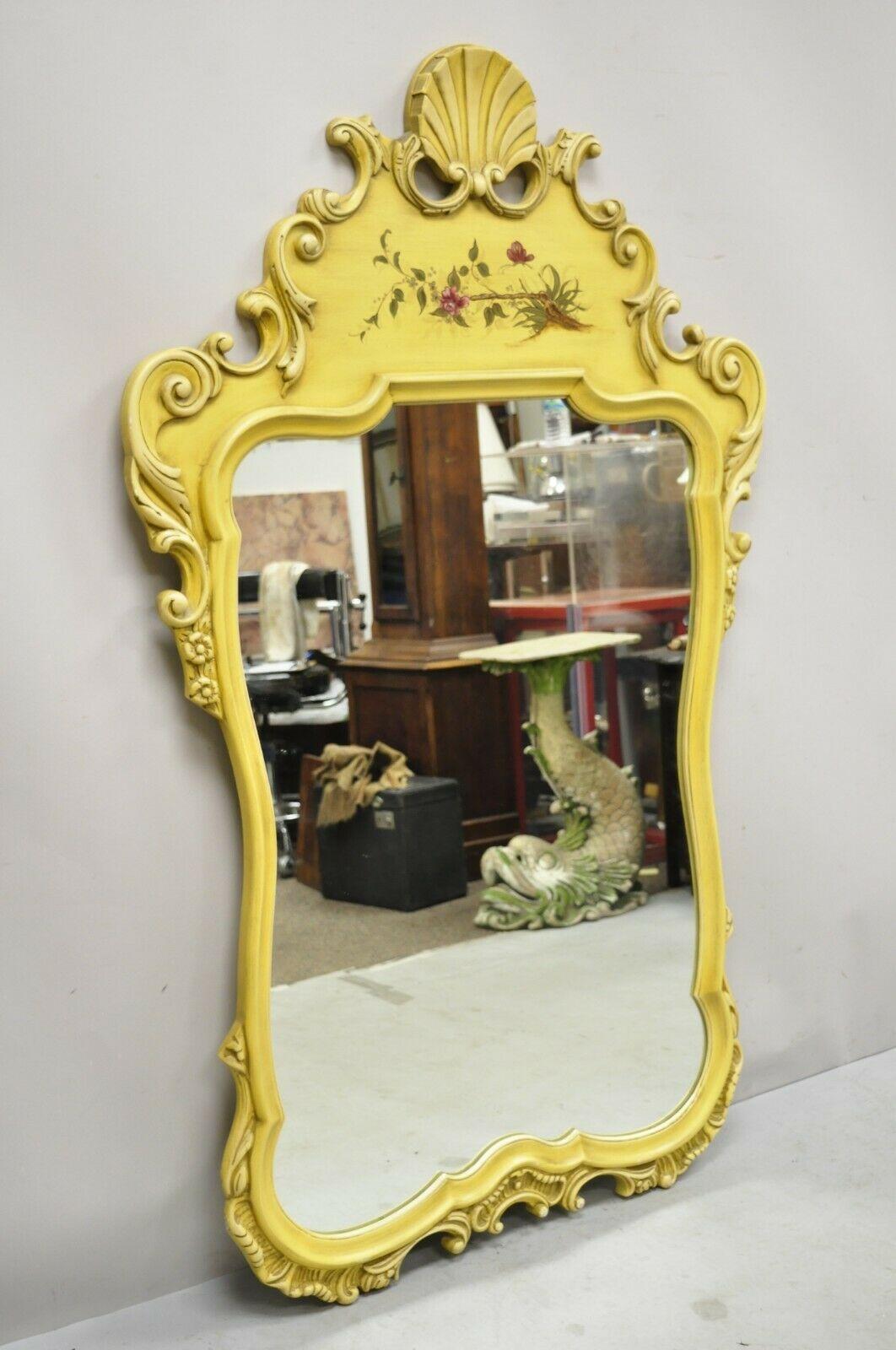 Vintage Yellow Chinoiserie shell carved wall mirror by Union National. Item features hand painted floral detail, shell carved pediment, original yellow finish, nicely carved details, quality American craftmanship, great style and form. Circa. Mid