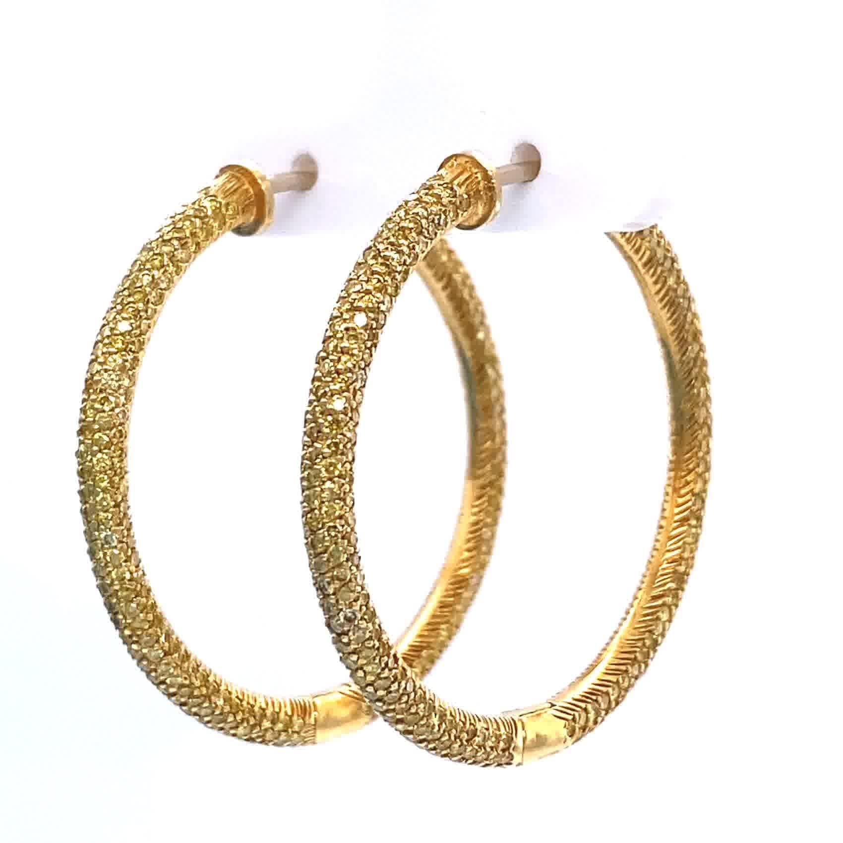 If you like to stand out from the crowd and own something truly unique, these Vintage Yellow Diamond 18k Gold Hoop Earrings are for you! They feature 700 round brilliant cut fancy yellow diamonds weighing approximately 5.00 carat. Fancy yellow