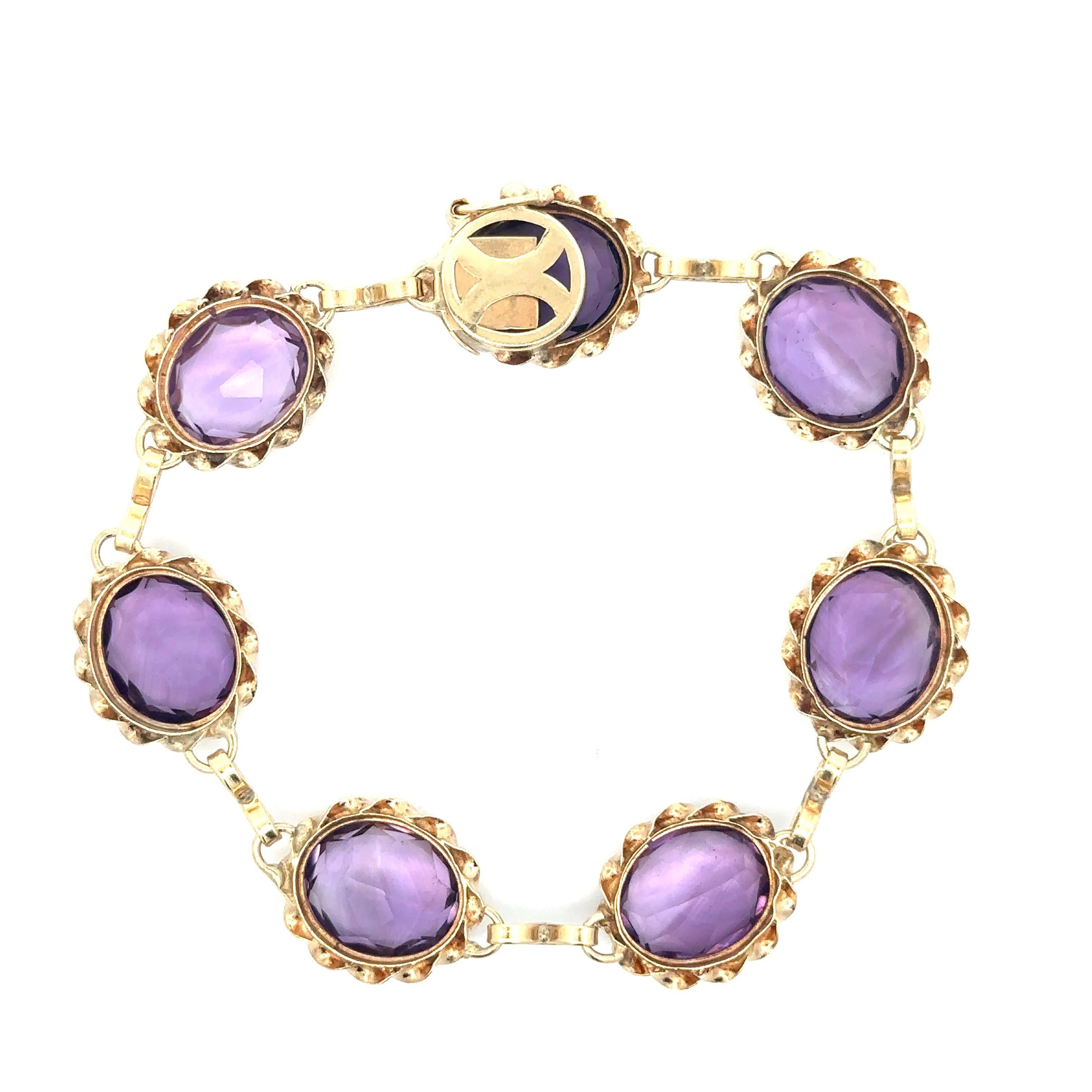–Stone(s)–
(7) Natural Genuine Amethysts - Oval Brilliant Cut - Bezel Set - Purple Color - Range from 12.6x10.2mm to 12.8x10.5mm- 30ctw (approx.)

Material: Solid 14k Yellow Gold
Weight: 19.04 Grams
Length: Measure 7.25 Inches Next to a Ruler. Will