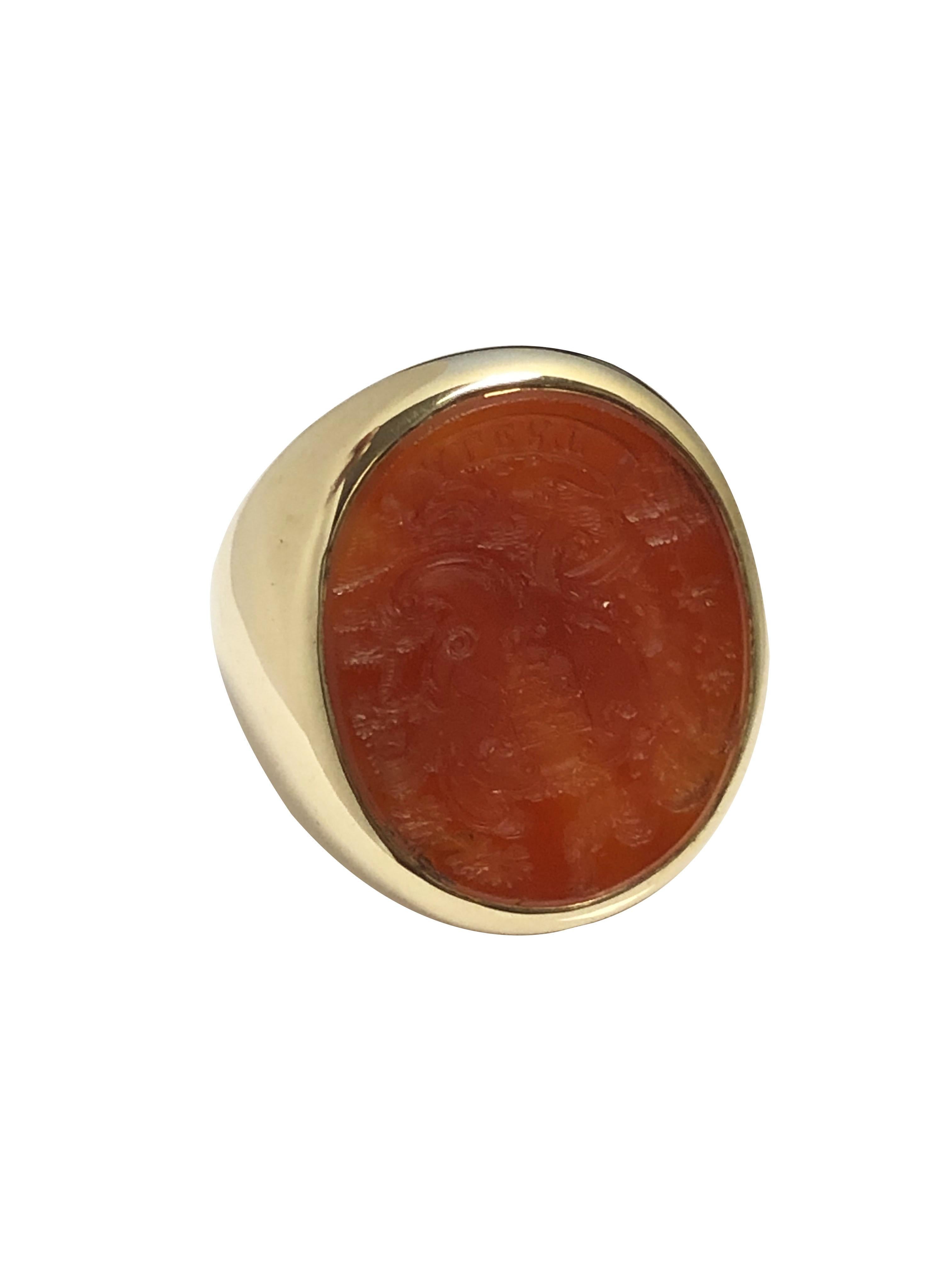 Circa 1920 - 1930 14k Yellow Gold Crest Ring, An impressive large Ring measuring 1 inch in length across the top and 7/8 inch wide and having wide shoulders / sides and weighing 19.9 Grams. Set with a Red orange carved Carnelian with a European