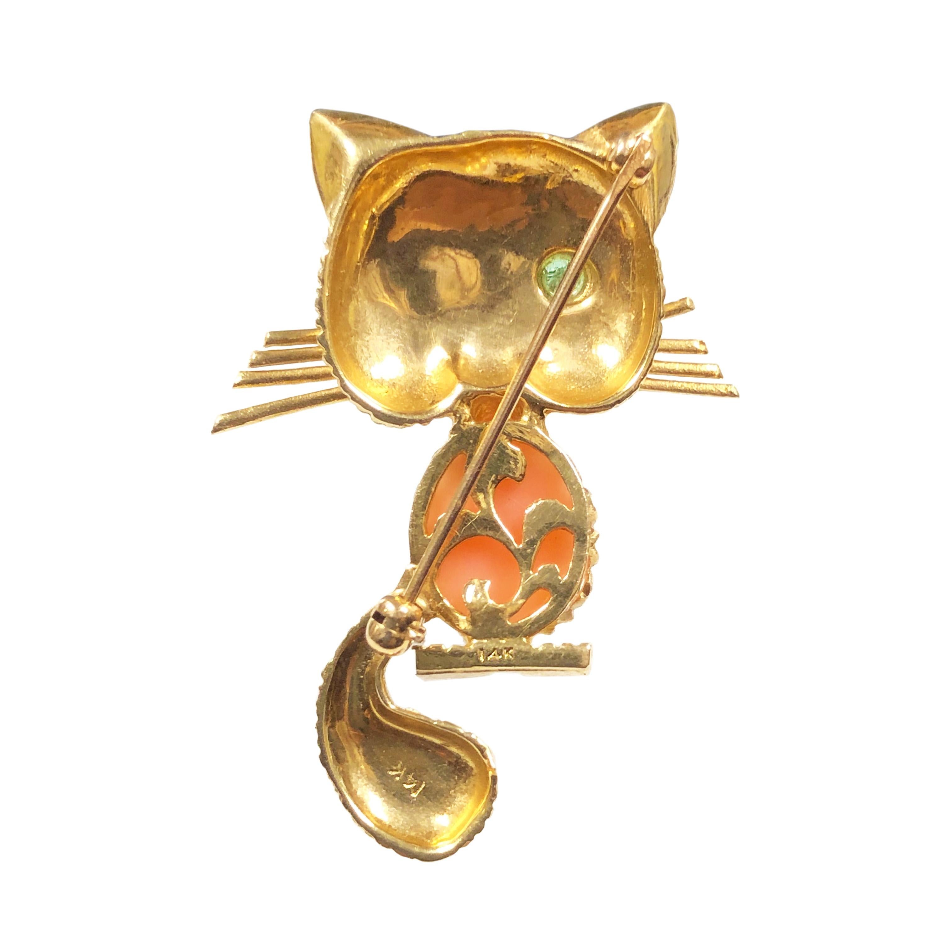 Circa 1960s copy of the famous VCA winking Kitty Brooch, 14k Yellow Gold and measuring 1 3/4 inches in length x 1 1/8 inch wide, centrally set with a Coral and an Emerald in the Eye. Nicely detailed and looks exactly like the Van Cleef counterpart.