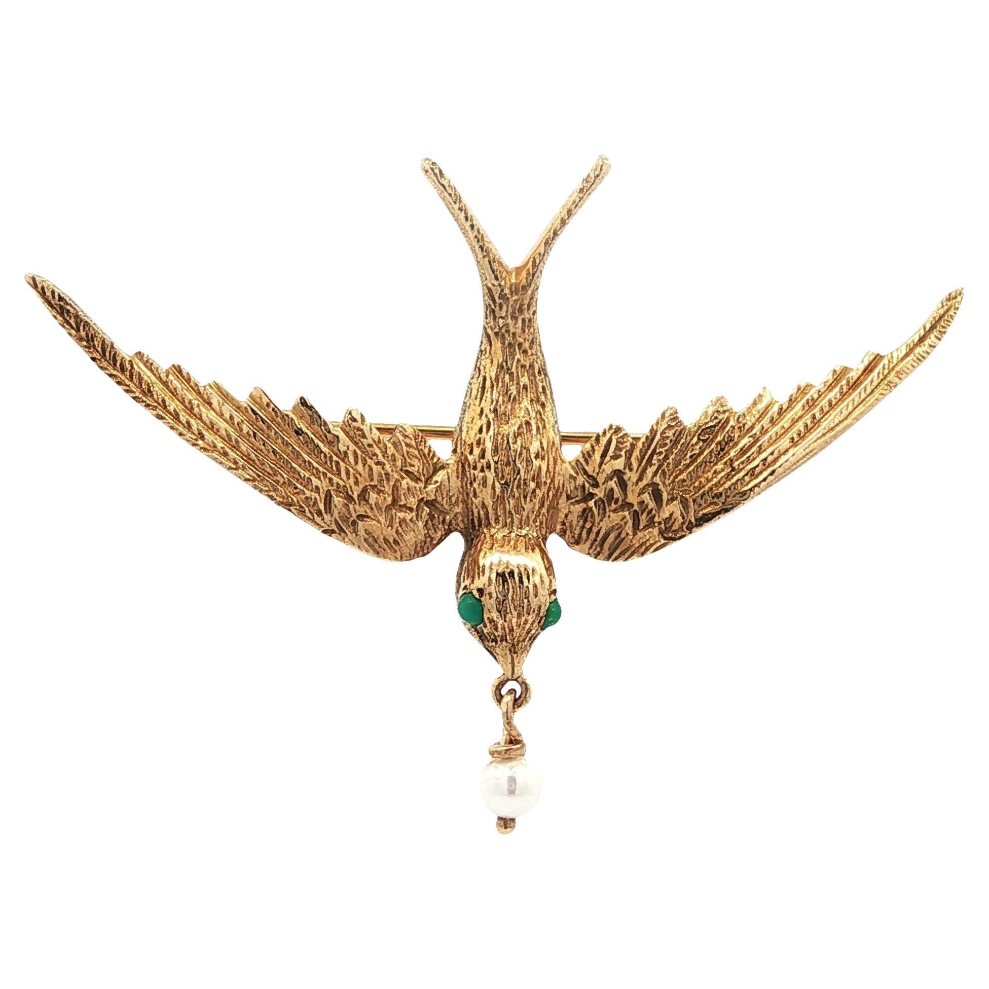 Broche vintage de oro amarillo con detalle de ave golondrina ojos de turquesa y perla colgante