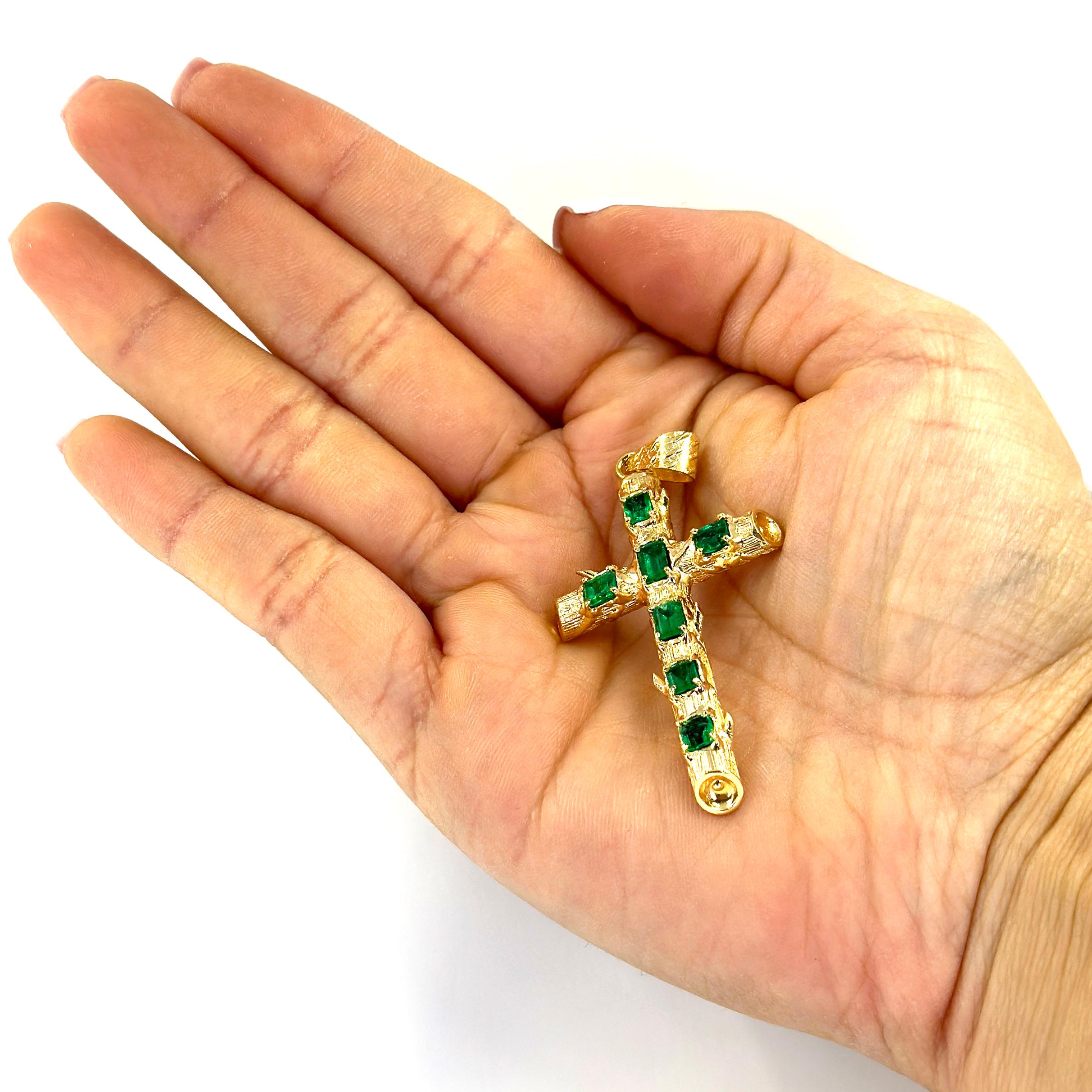 18 Karat Yellow Gold Cross with Branch Design Featuring 7 Emeralds Totaling Approximately 2.50 Carats. 2.25 Inches Long. Finished Weight is 7.5 Grams.
