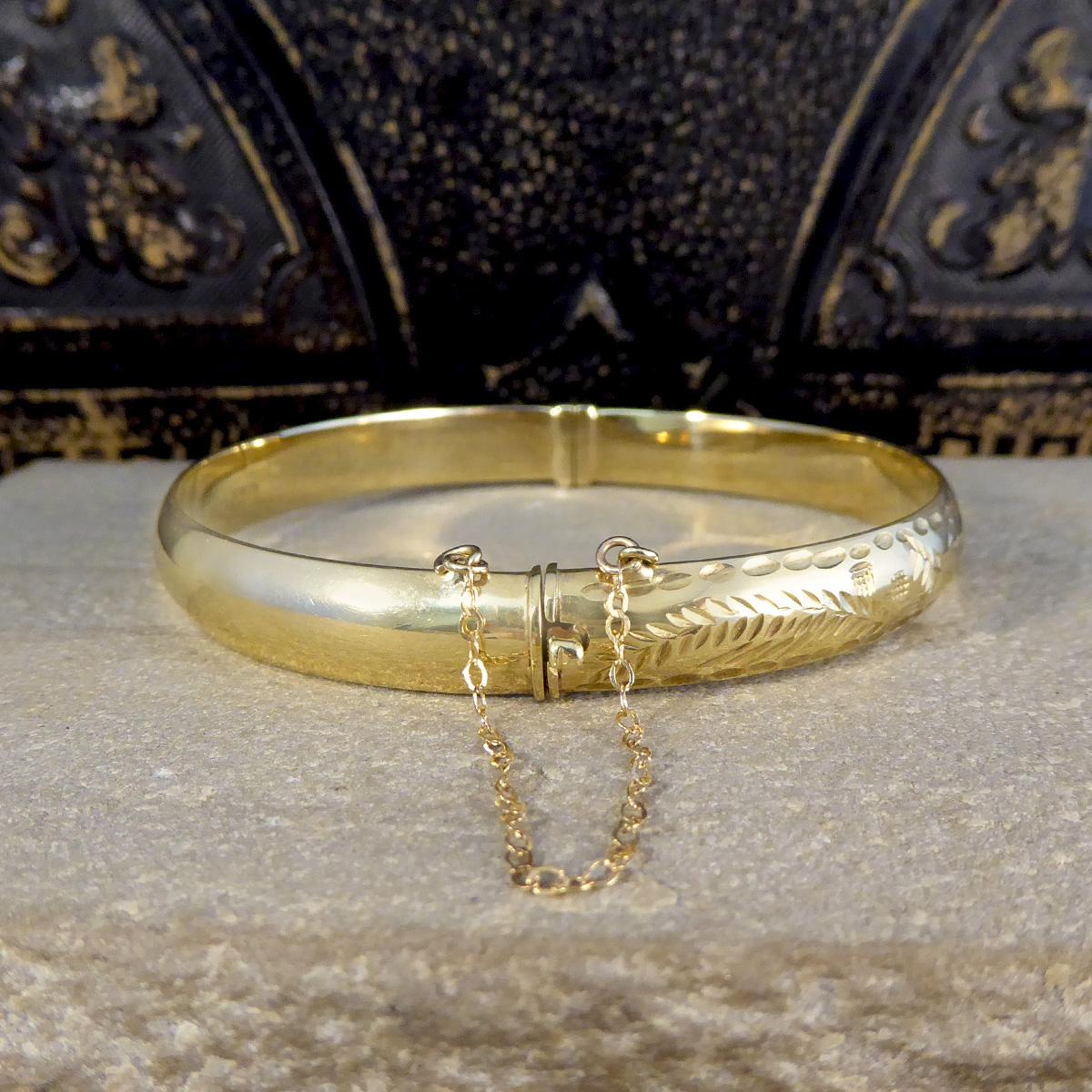 gold bangle with safety chain