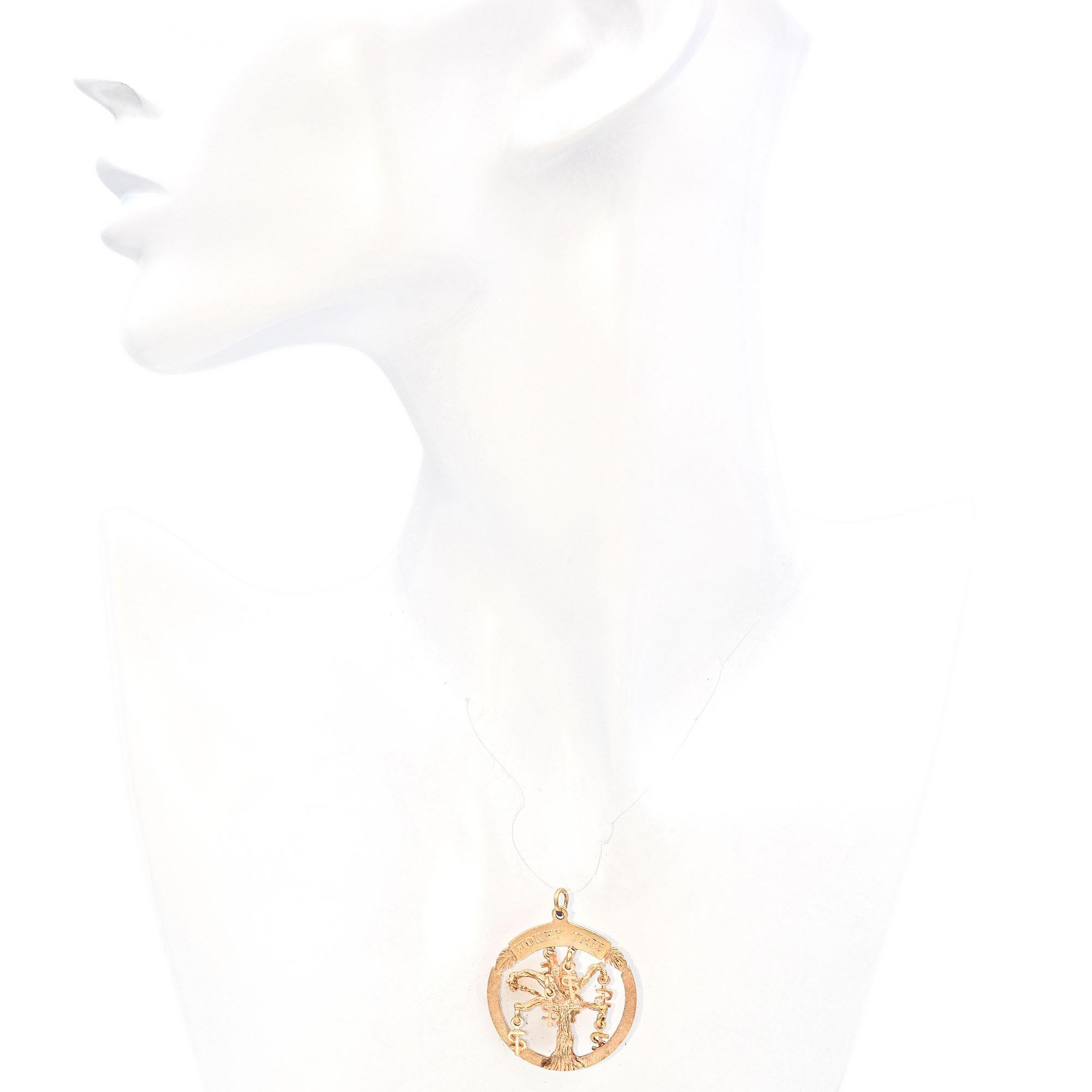 Crafted in 13k gold, this intriguing piece features a circular open frame with a detailed 3 Dimensional tree design at its center.
The tree is adorned with dangling United States currency symbol charms, adding a whimsical touch to the piece.
The top