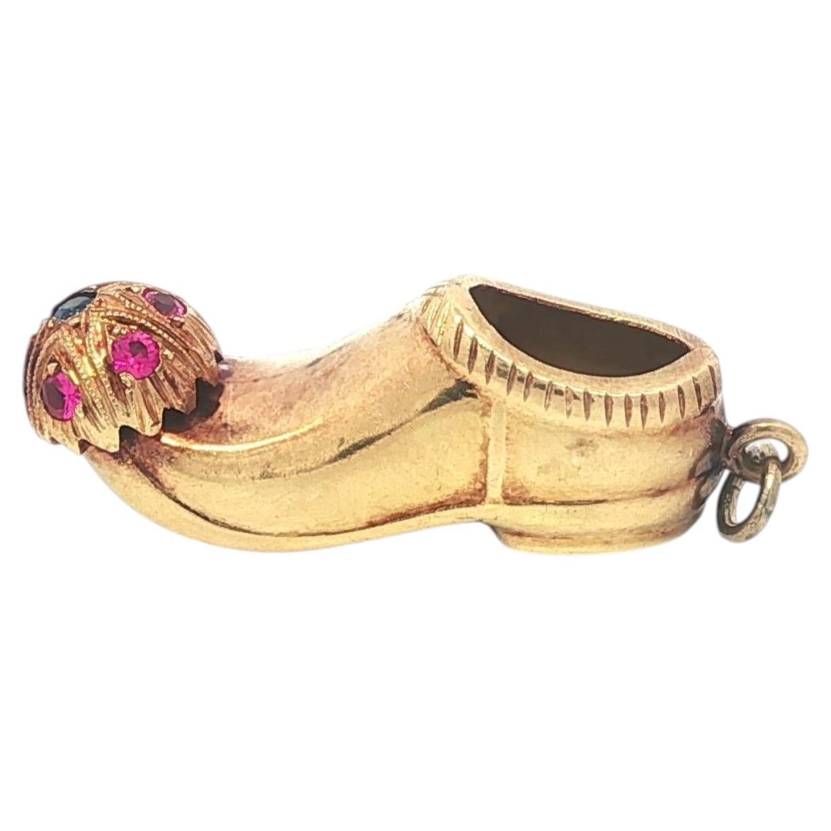 Colgante de oro amarillo vintage con piedras rojas y azules con forma de zapatilla de genio