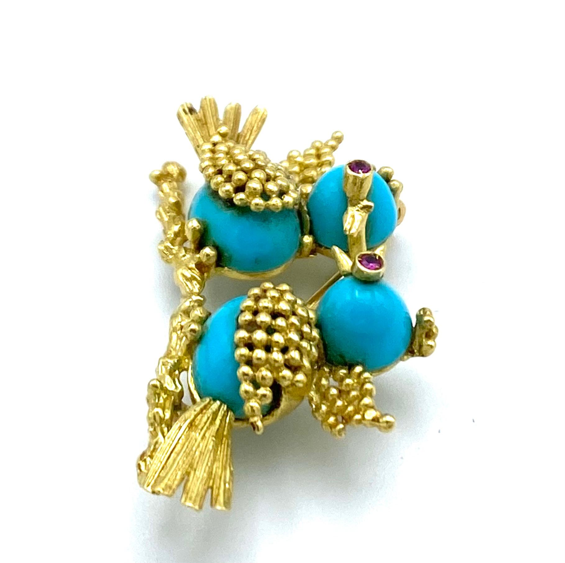 Product details:

The brooch is made out of 14 karat yellow gold, turquoise and detailed with ruby as birds eyes. It is featuring love birds on the branch.