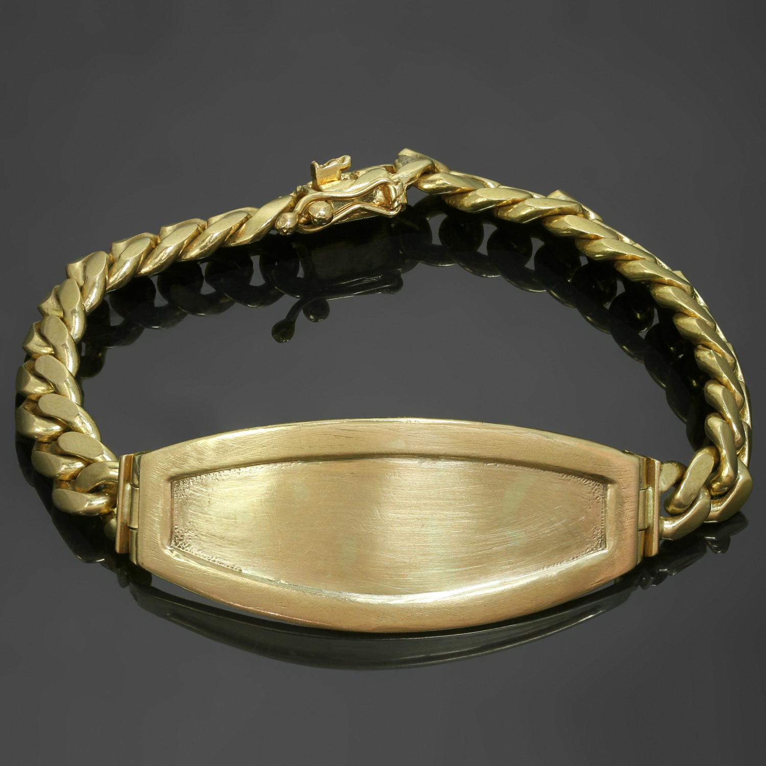 Ce bracelet d'identité unisexe classique et vintage est fabriqué en or jaune 18 carats. Fabriqué aux États-Unis dans les années 1980. Mesures : 7.19,5 cm de long, 20 mm de large, 7 mm de large pour la chaîne. D'occasion. Présente quelques signes