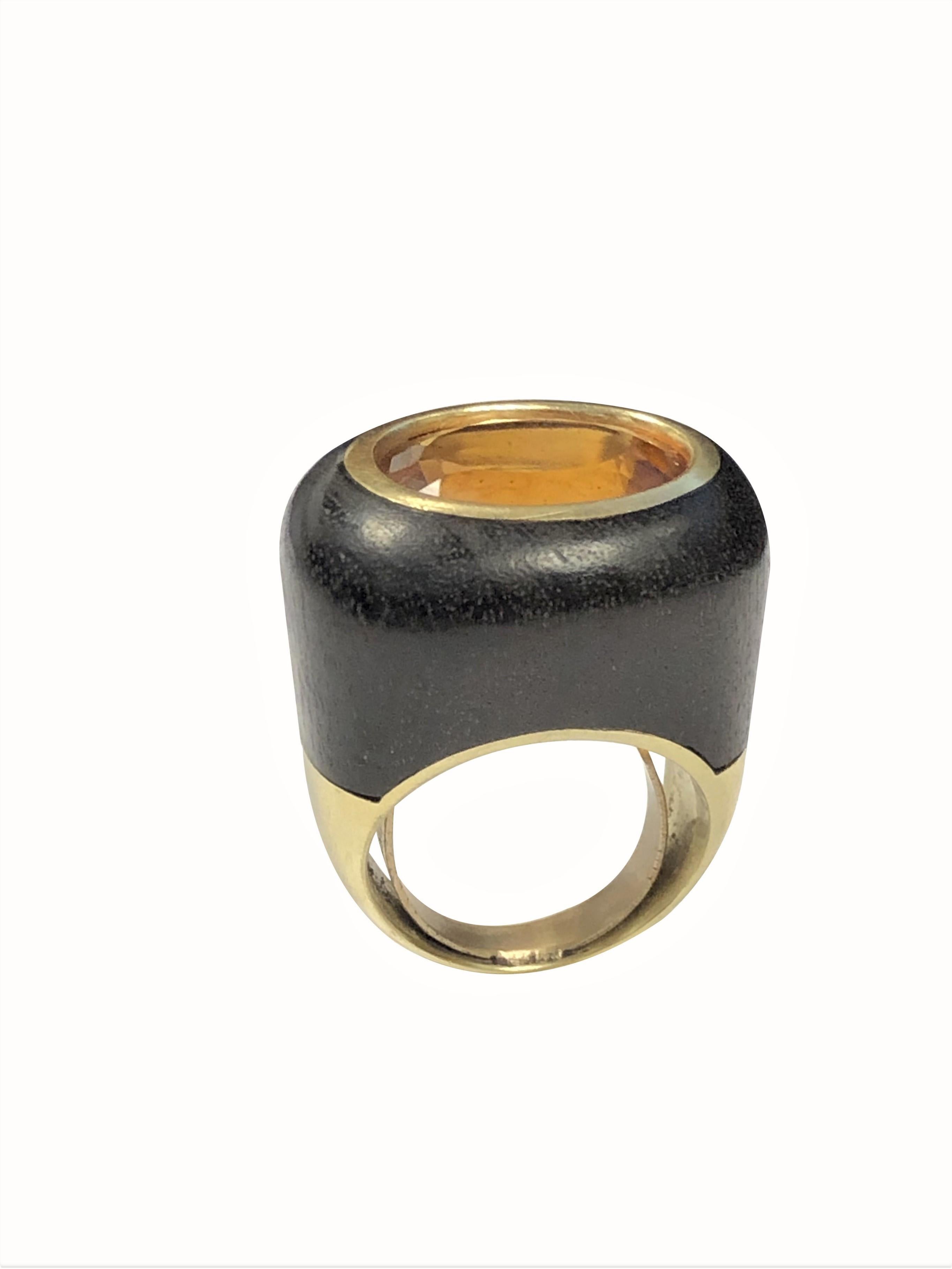 Circa 1980s 18K Yellow Gold Large Cocktail Ring, having a solid Mahogany wood central section, measuring 3/4 inch wide,  1 inch in length with the top of the ring measuring 7/8 X 3/4 inch. A very fine Color Oval Golden Topaz measuring 15 X 12 M.M.