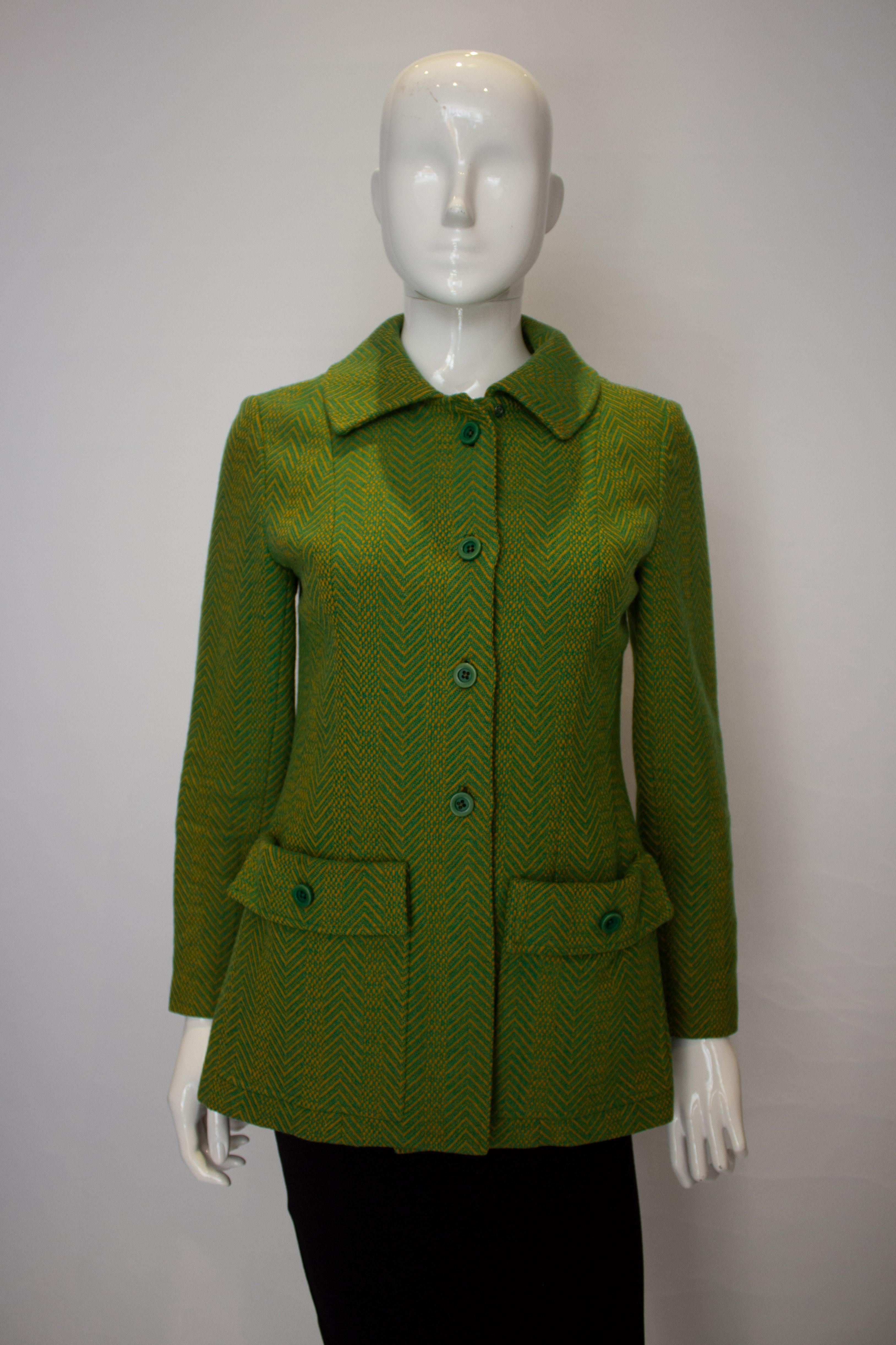 A fun vintage  jacket by Marcus boutique , London. The jacket is an interesting mix of colours and weaves. It is unlined and has a four button opening and two pouch pockets at the front.