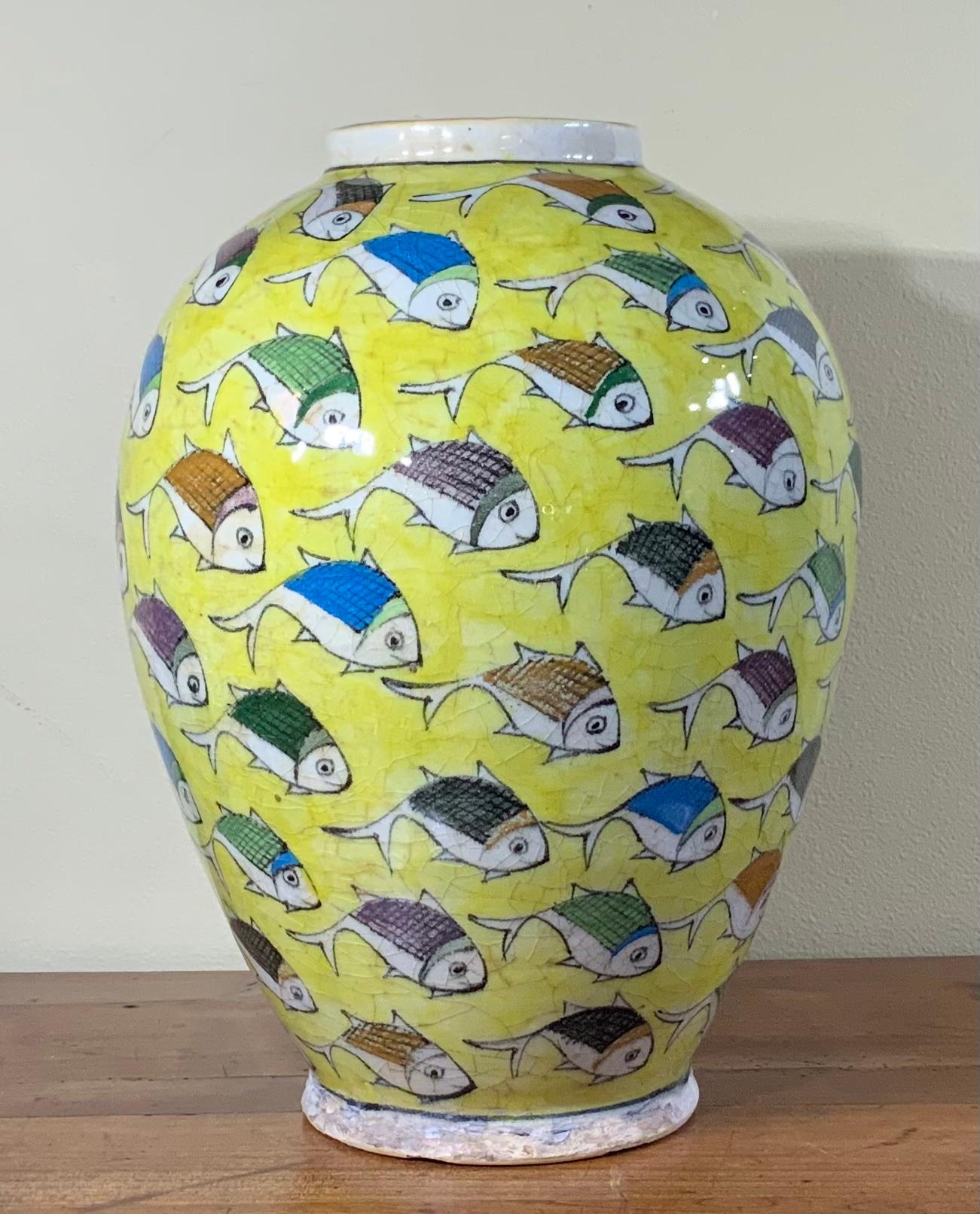 Beautiful yellow ceramic vase hand-painted and glazed with colorful fish motif surrounding on yellow background. Great object of art for display.