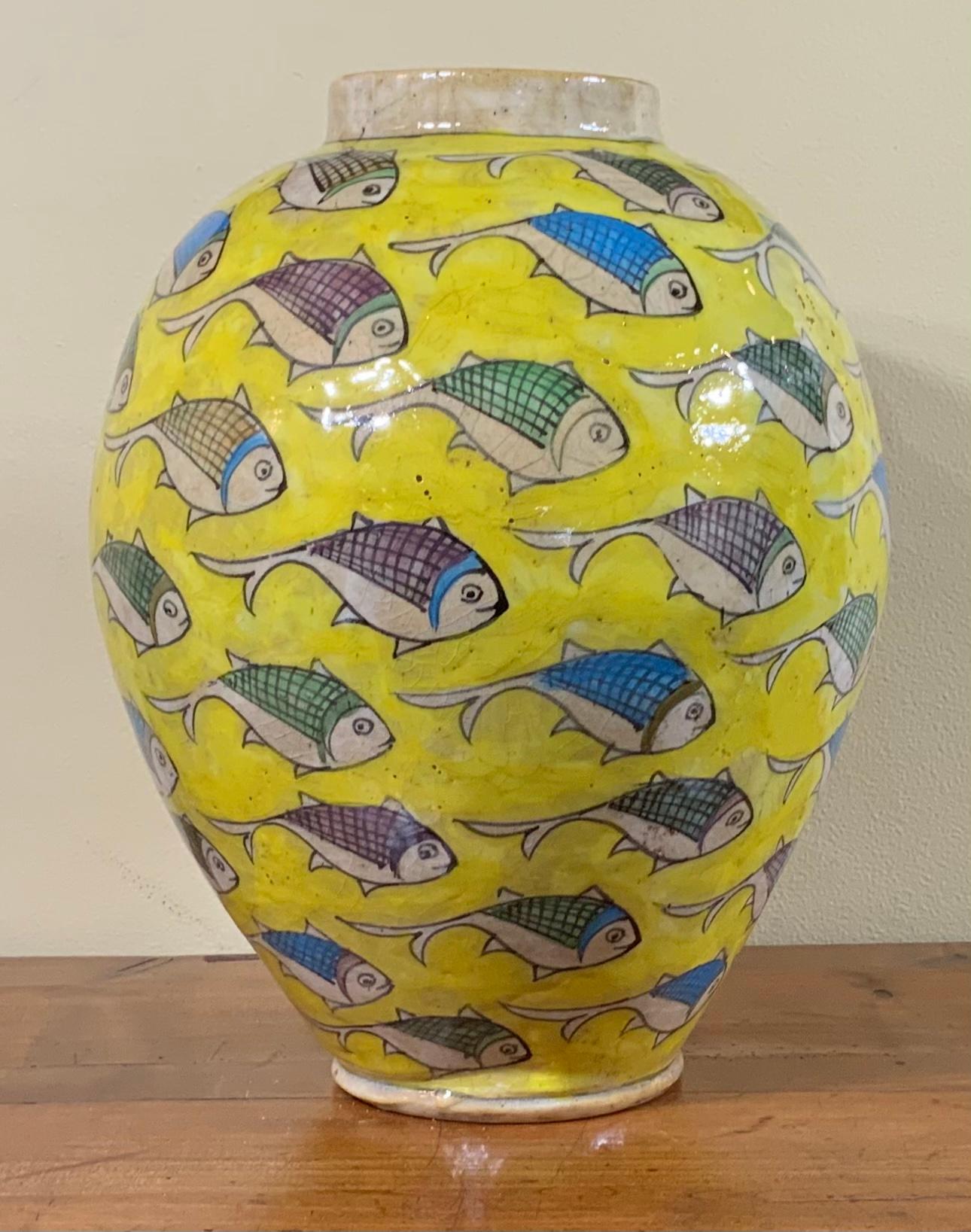 Beautiful yellow ceramic vase hand-painted and glazed with colorful fish motif surrounding on yellow background. Great object of art for display.
