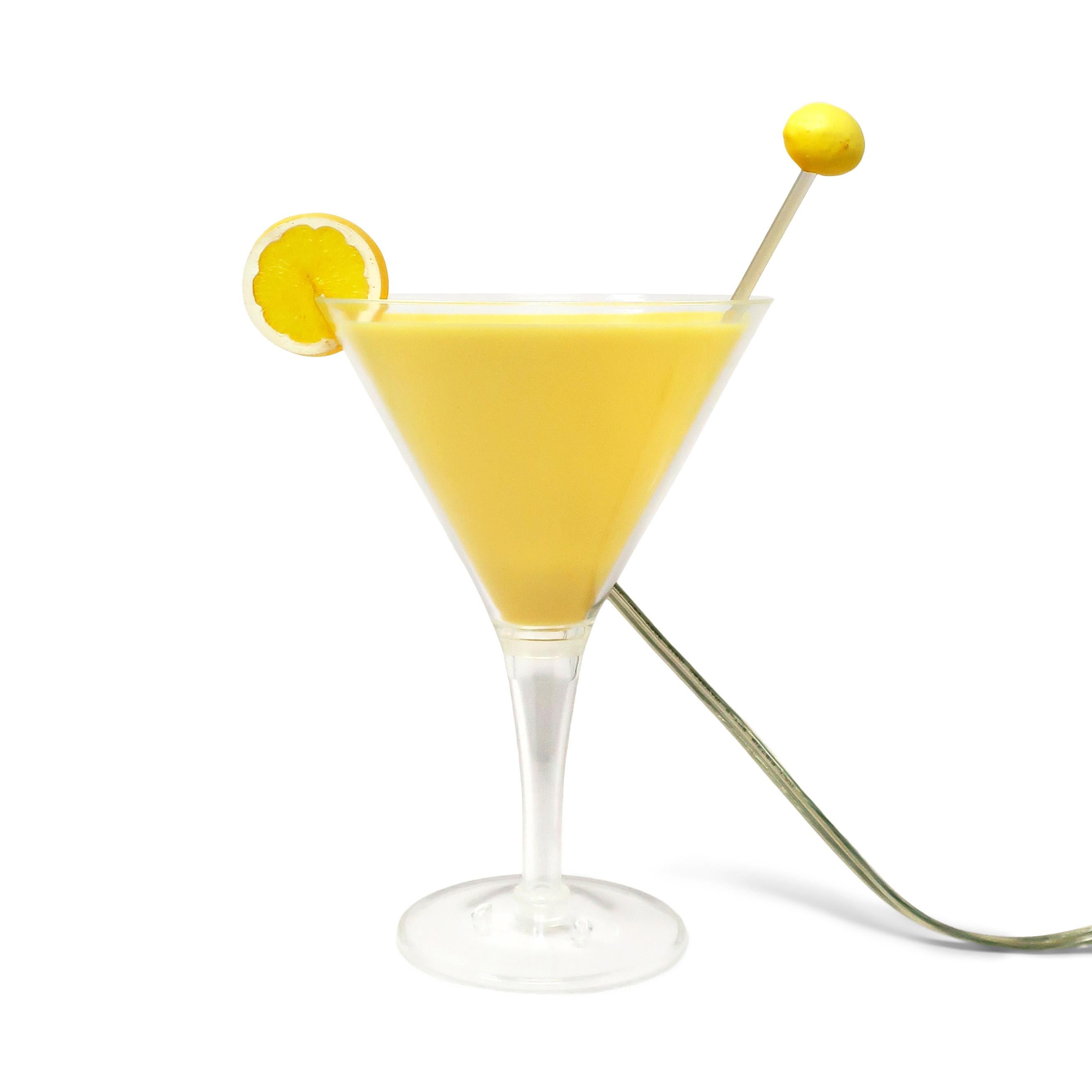A hard-to-find postmodern cocktail lamp with a clear lucite martini-shaped glass, yellow shading to look like a full lemon drop cocktail, and a stick with a slice of lemon on the end. Great for lovers of pop art, barware, martinis, or awesome