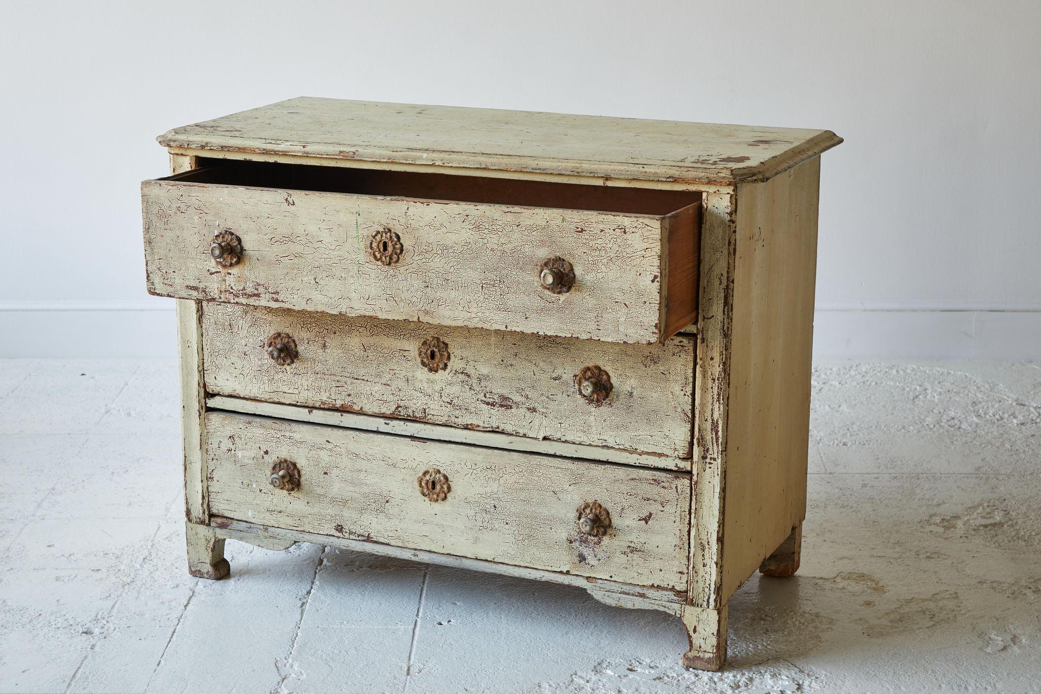 Vintage yellow painted three drawer chest of drawers with original hardware florets. The original finish is aged and crackled with boasts the character and patina of the dresser.