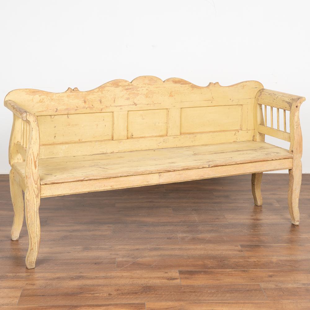 This delightful bench reminds one of a warm summer day in the European countryside. The yellow paint is all original, but has been naturally worn and distressed over time revealing the natural pine below, all adding to the character and charm of the