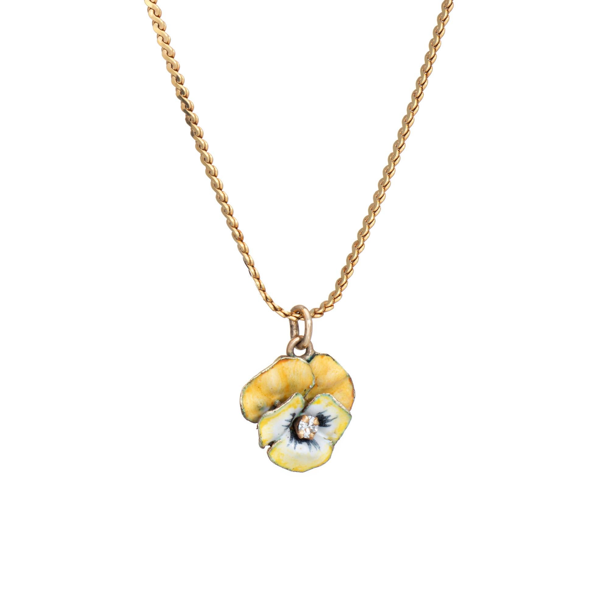 Finely detailed vintage pansy necklace crafted in 14 karat yellow gold (circa 1950s). 

One small diamond is estimated at approx. 0.03 carats (estimated at I-J color and SI2-I1 clarity). The beautifully enameled yellow pansy is a lovely example of