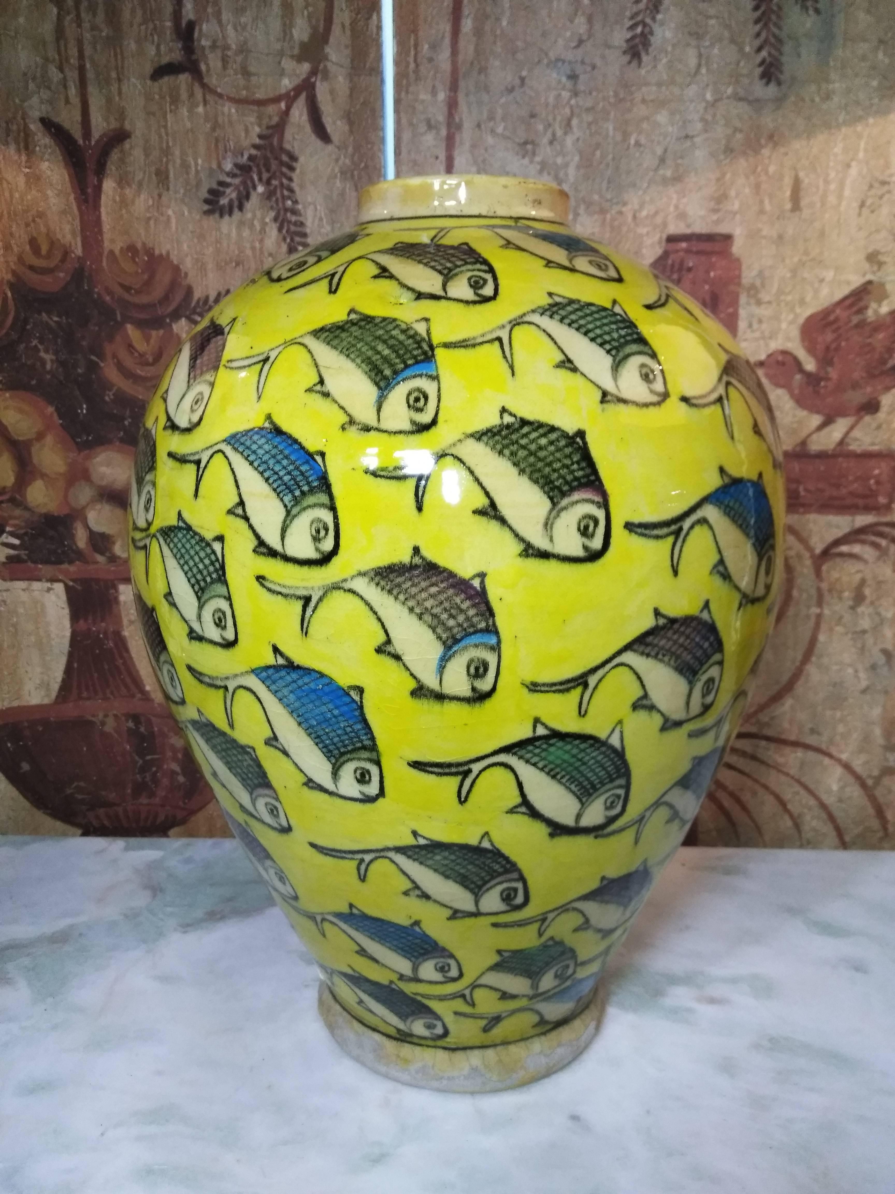 Beautiful yellow Persian ceramic vase hand-painted and glazed with colorful fish motif surrounding it. Great decorative piece of art for display.