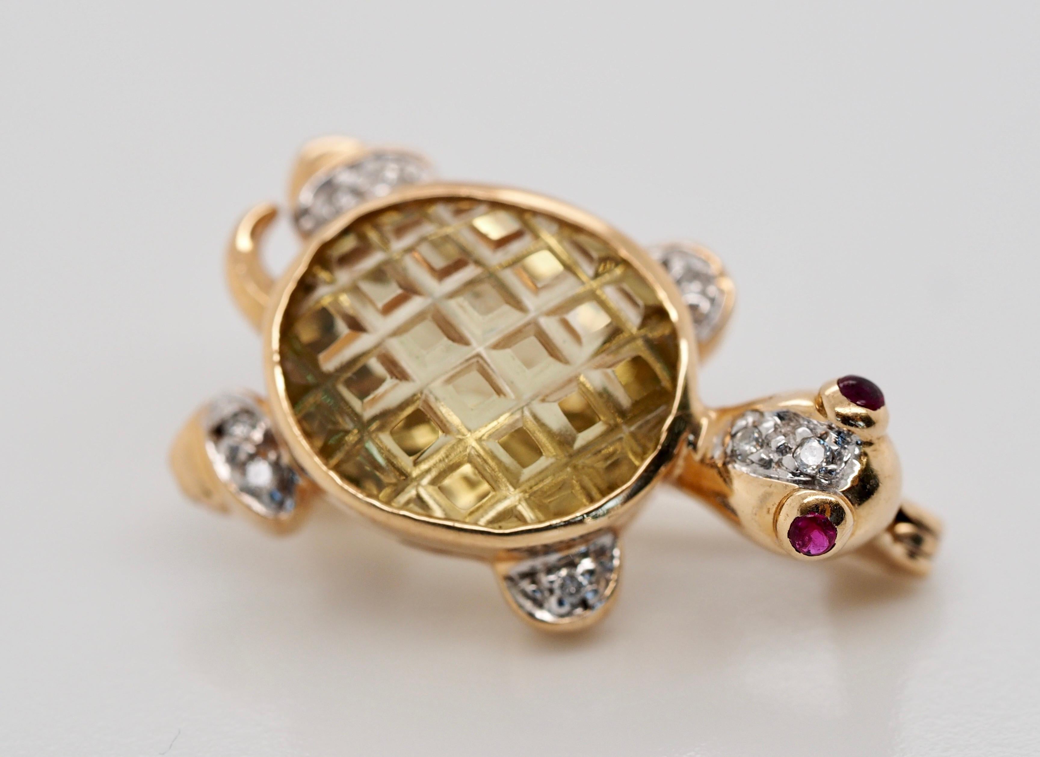 This adorable vintage brooch is such a fun and unique piece! It features a sweet little tortoise made up of different types of stones. For the body there is a stunning scissor-cut yellow quartz oval, and there are two lovely rubies for eyes, while