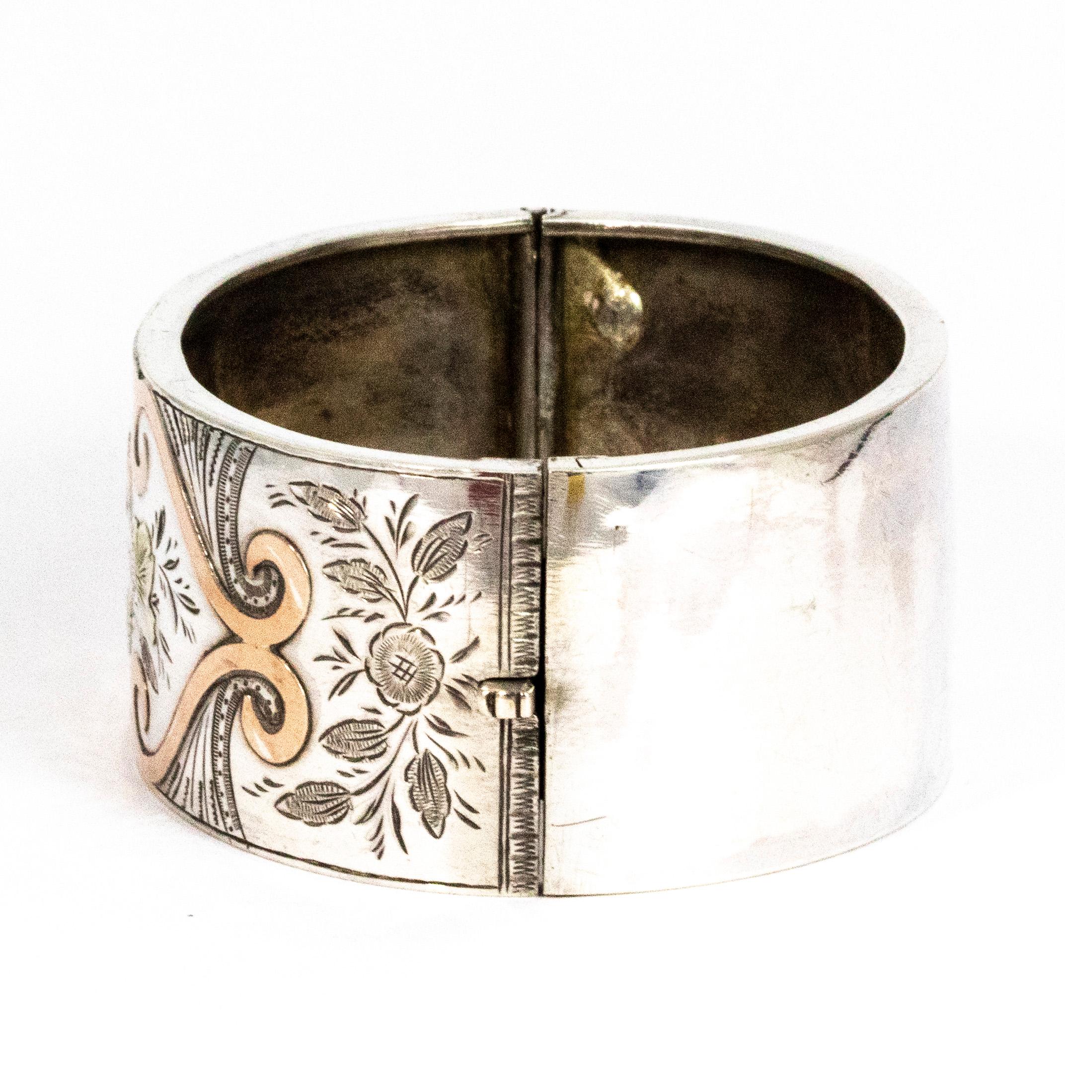 This gorgeous silver bangle has the most exquisite rose gold and yellow gold overlay. There is also engraving included in the decoration of this stunning piece. The overall feel of the design on the bangle is a girly floral style. 

Inner Diameter: