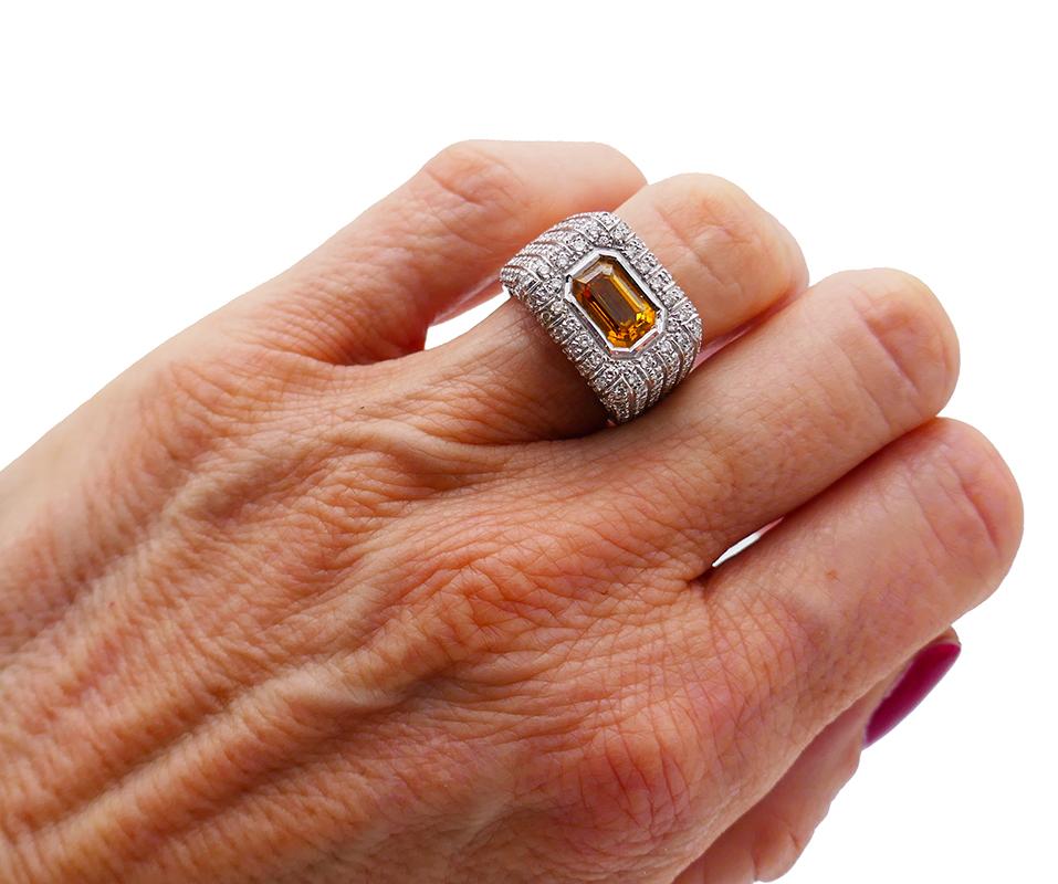 Classic cocktail ring made of 18 karat white gold (stamped) and featuring a 2.16-carat yellow sapphire accented with round brilliant cut diamonds (H-I color, VS clarity, 0.40 carat total). 
Measurements: Top 5/8