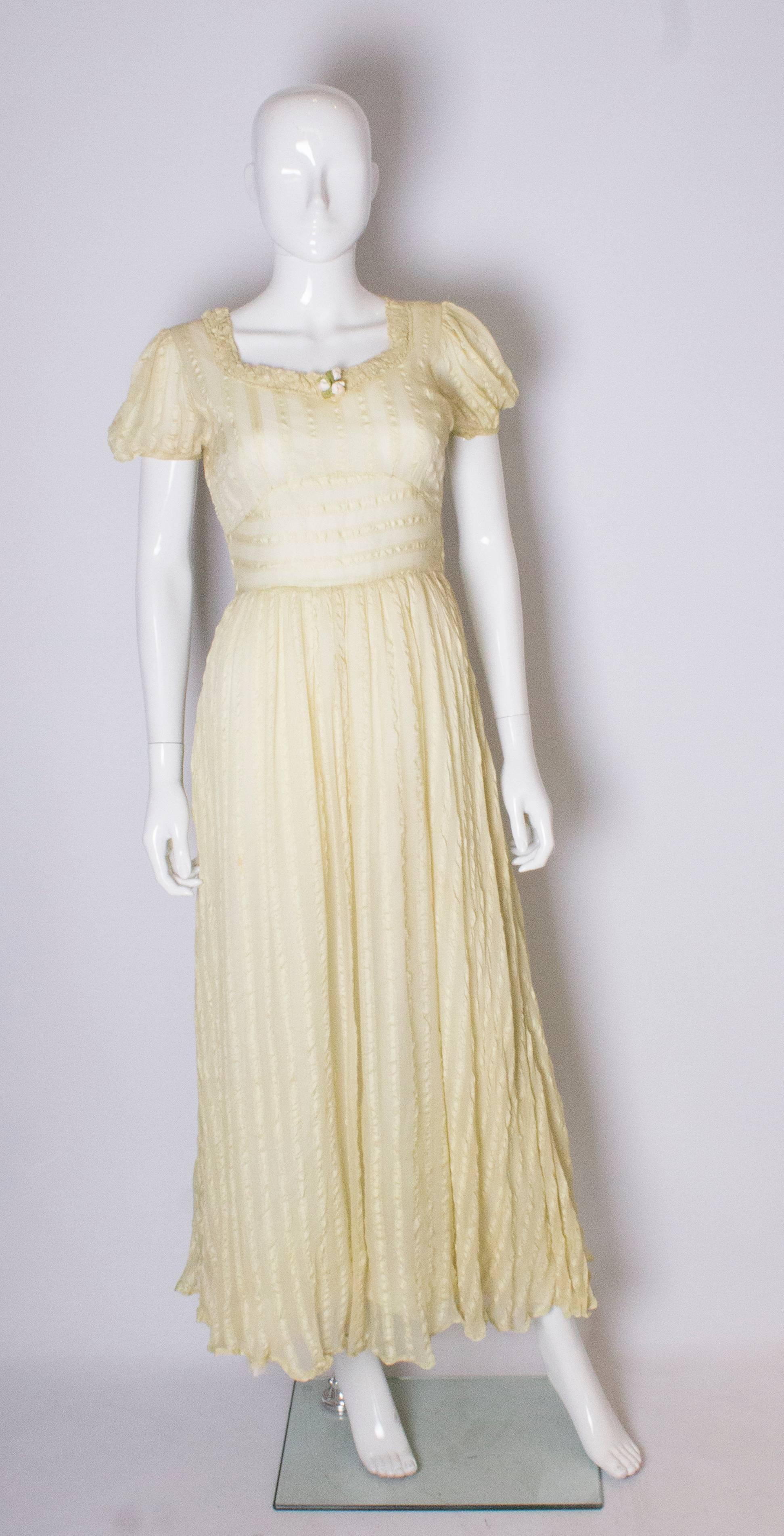 A great gown in a yellow silk with strip detail. The dress has puff sleeeves, a sweetheart neckline with gathering and zip opening on the left hand side. It is fully lined.
 