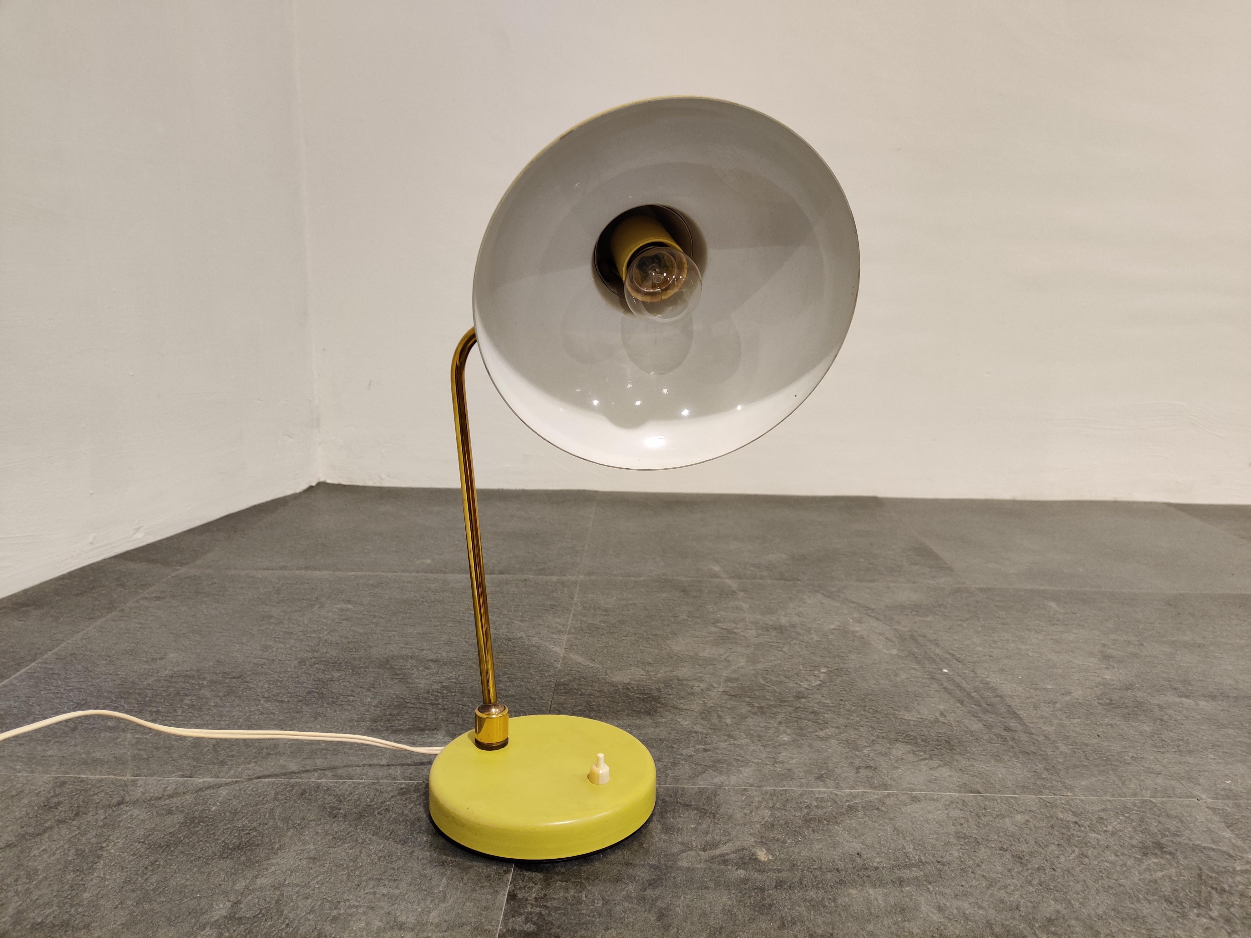 Midcentury yellow articulated desk lamp.

It can be adjusted at the base and at the shade which makes it very useful.

Good original condition.

The lamp takes a regular E27 light bulb.

Tested and ready to use.

1960s,